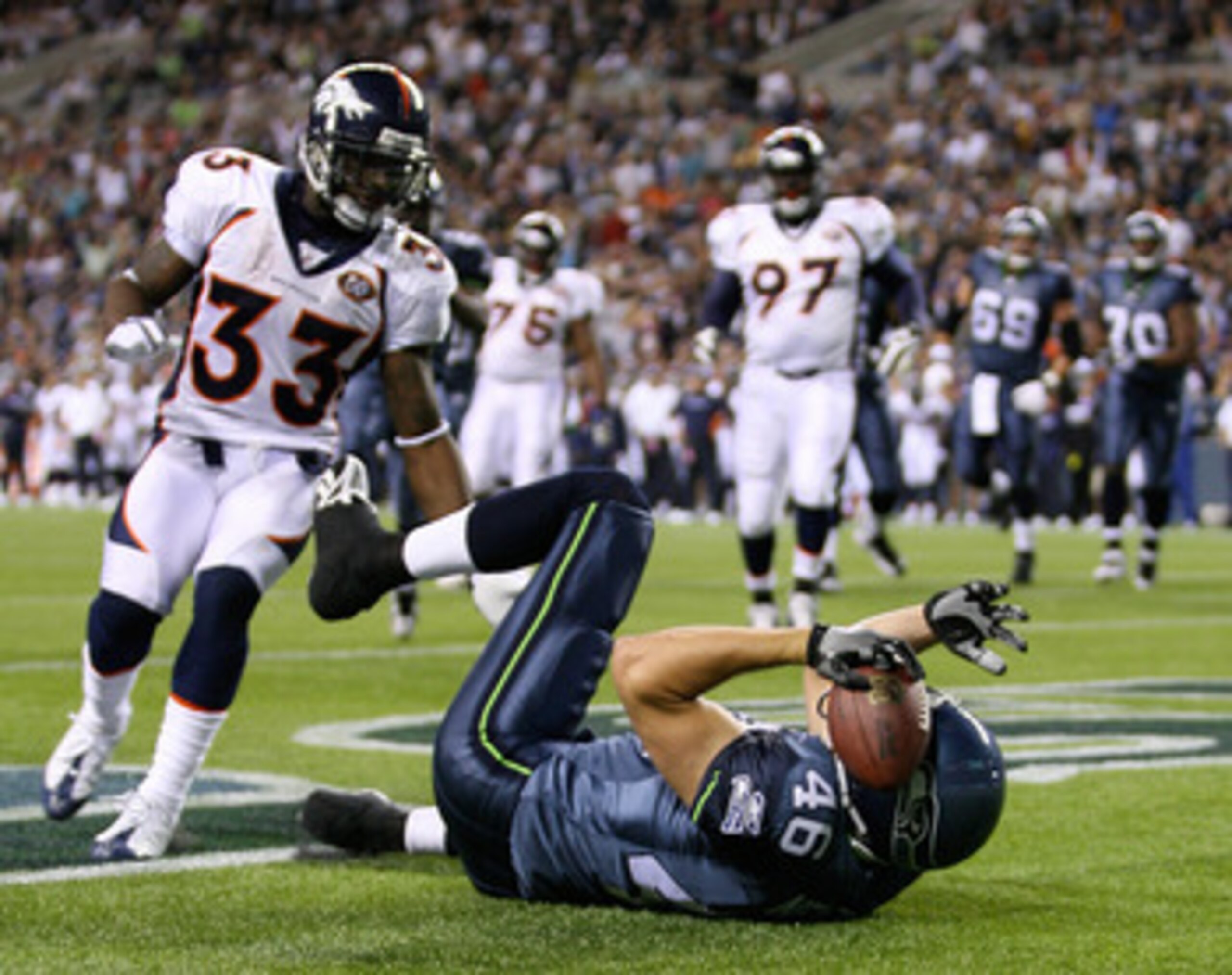 SEATTLE - AUGUST 22: Tight end Joe Newton #46 of the Seattle Seahawks makes a touchdown catch in the endzone against Alphonso Smith #33 of the Denver Broncos on August 22, 2009 at Qwest Field in Seattle, Washington. The Seahawks defeated the Broncos 27-1 SEATTLE - AUGUST 22: Tight end Joe Newton #46 of the Seattle Seahawks makes a touchdown catch in the endzone against Alphonso Smith #33 of the Denver Broncos on August 22, 2009 at Qwest Field in Seattle, Washington. The Seahawks defeated the Broncos 27-1