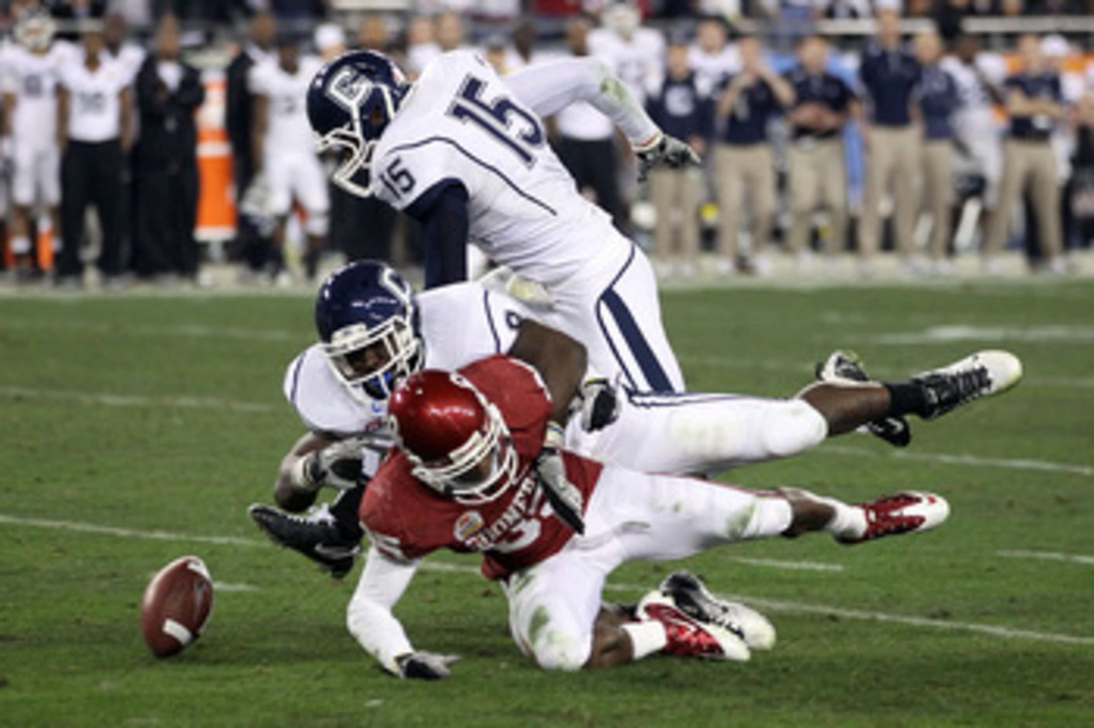 GLENDALE, AZ - JANUARY 01: Ryan Broyles #85 of the Oklahoma Sooners fumbles the ball as it is stripped by Lawrence Wilson #8 of the Connecticut Huskies alongside Jerome Junior #15 in the second half during the Tostitos Fiesta Bowl at the Universtity of P GLENDALE, AZ - JANUARY 01: Ryan Broyles #85 of the Oklahoma Sooners fumbles the ball as it is stripped by Lawrence Wilson #8 of the Connecticut Huskies alongside Jerome Junior #15 in the second half during the Tostitos Fiesta Bowl at the Universtity of P