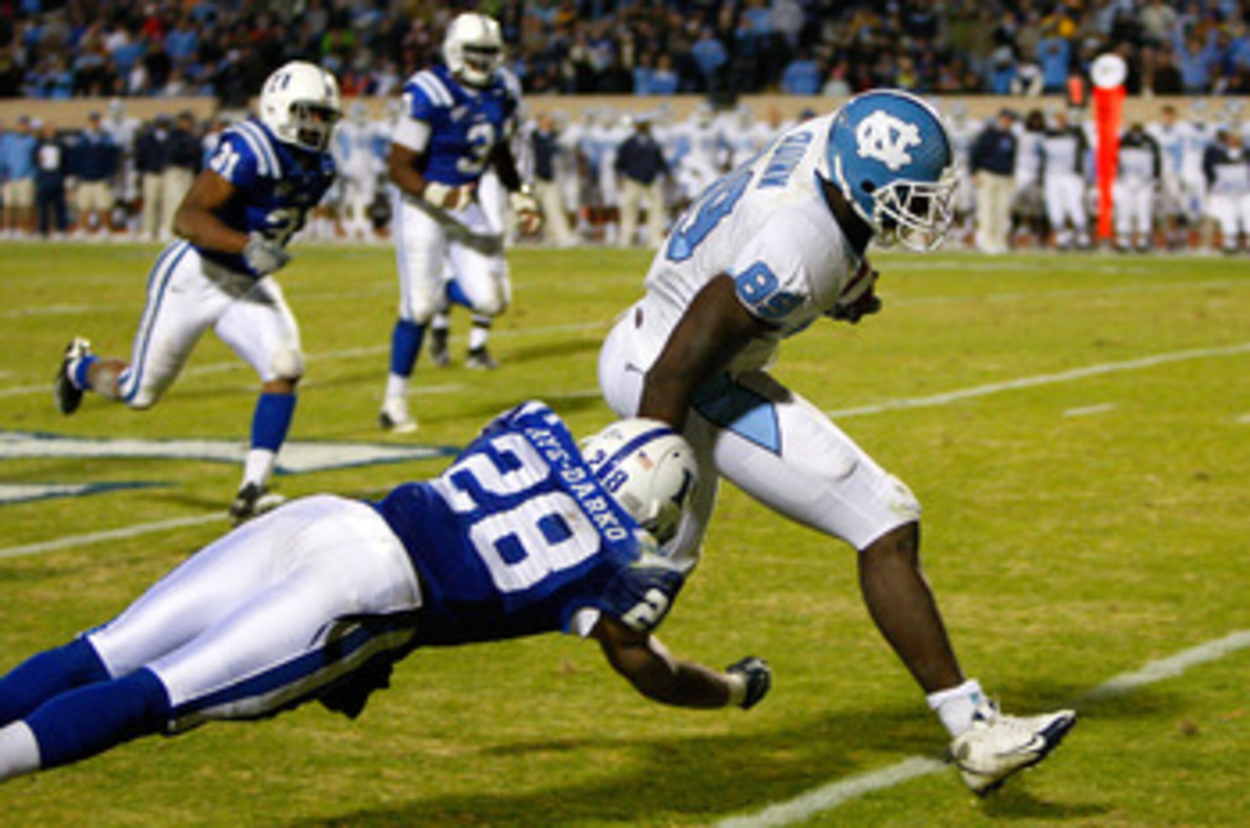 DURHAM, NC - NOVEMBER 29: Tight end Richard Quinn #89 of the North Carolina Tar Heels breaks a tackle by Adrian Aye-Darko #28 of the Duke Blue Devils on his way to a touchdown during the game at Wallace Wade Stadium on November 29, 2008 in Durham, North DURHAM, NC - NOVEMBER 29: Tight end Richard Quinn #89 of the North Carolina Tar Heels breaks a tackle by Adrian Aye-Darko #28 of the Duke Blue Devils on his way to a touchdown during the game at Wallace Wade Stadium on November 29, 2008 in Durham, North