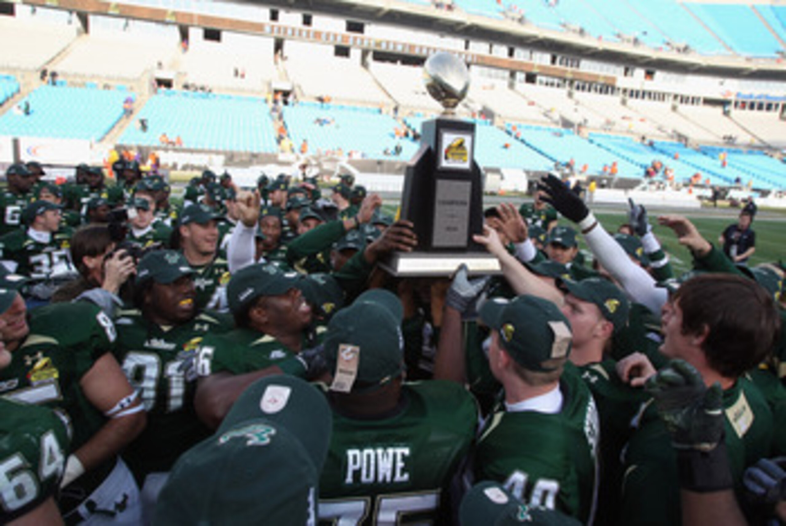 CHARLOTTE, NC - DECEMBER 31:  The USF Bulls celebrate with the trophy after a 31-26 victory over the Clemson Tigers at Bank of America Stadium on December 31, 2010 in Charlotte, North Carolina.  (Photo by Streeter Lecka/Getty Images)