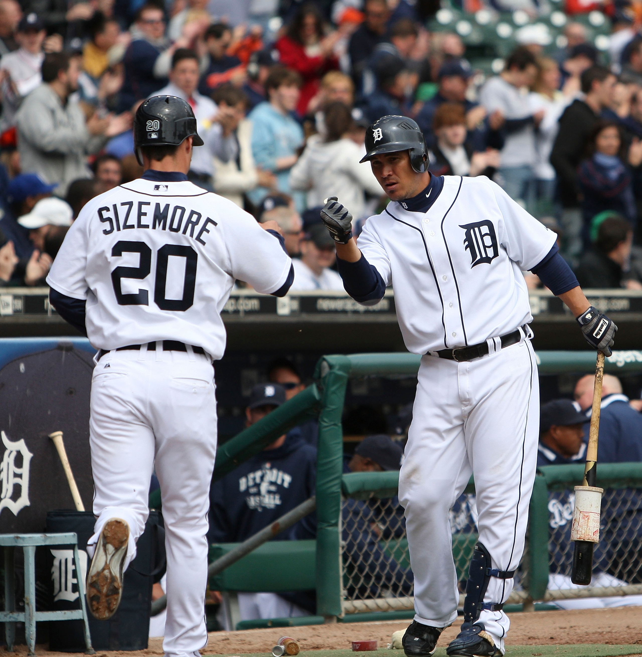 DETROIT - APRIL 13:  Magglio Ordonez #30 of the Detroit Tigers congratulates Scott Sizemore #20 after scoring on a double to left-center off the bat of Austin Jackson #14 in the seventh inning of their game against the Kansas City Royals on April 13, 2010