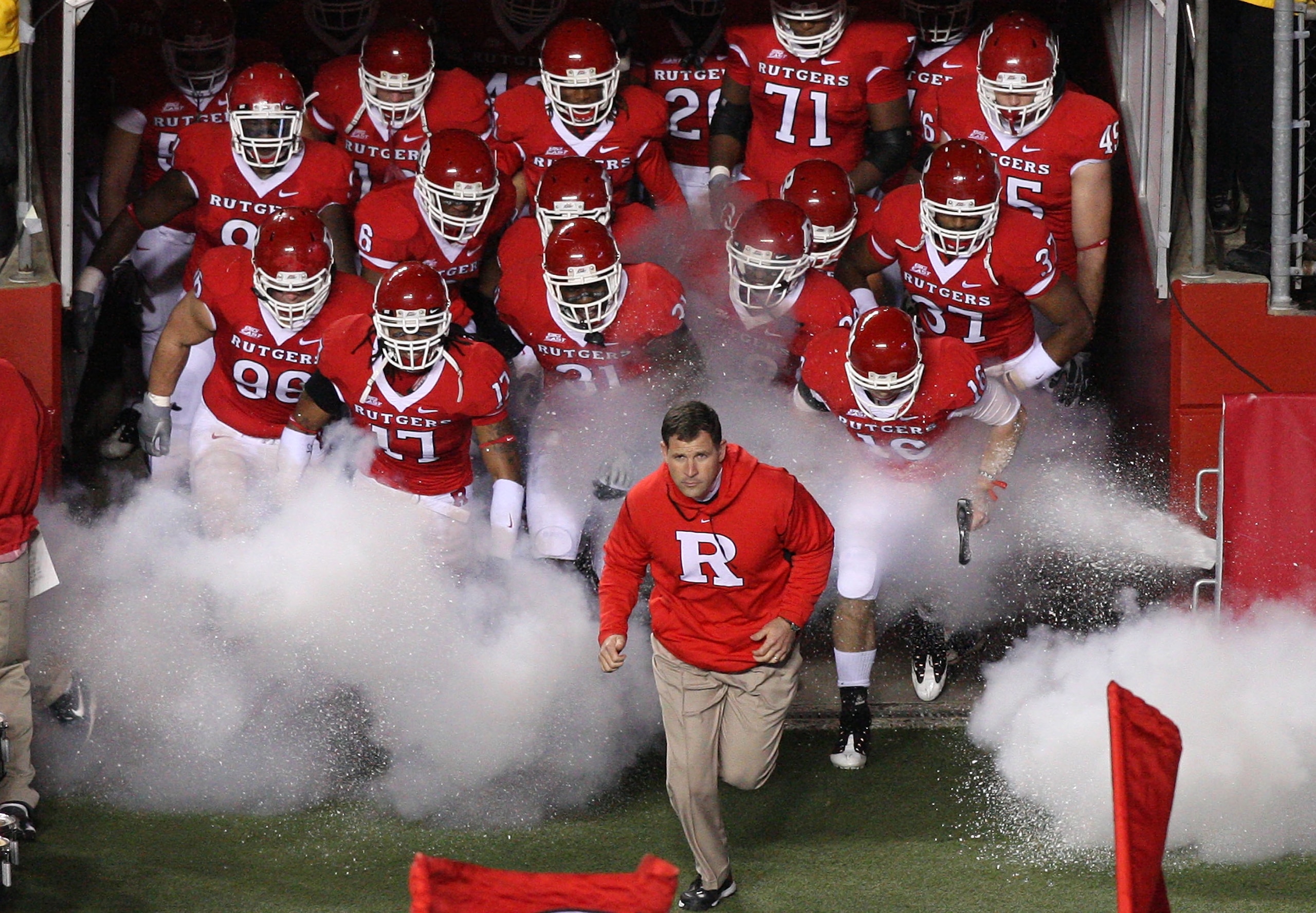PISCATAWAY, NJ - NOVEMBER 12: Head coach Greg Schiano of the Rutgers Scarlet Knights leads his team on the field to play against the South Florida Bulls at Rutgers Stadium on November 12, 2009 in Piscataway, New Jersey. (Photo by Jim McIsaac/Getty Image PISCATAWAY, NJ - NOVEMBER 12: Head coach Greg Schiano of the Rutgers Scarlet Knights leads his team on the field to play against the South Florida Bulls at Rutgers Stadium on November 12, 2009 in Piscataway, New Jersey. (Photo by Jim McIsaac/Getty Image