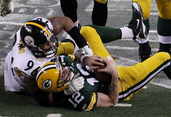ARLINGTON, TX - FEBRUARY 06:  Aaron Rodgers #12 of the Green Bay Packers is sacked by Ziggy Hood #96 of the Pittsburgh Steelers during the fourth quarter of Super Bowl XLV at Cowboys Stadium on February 6, 2011 in Arlington, Texas.  (Photo by Jonathan Dan