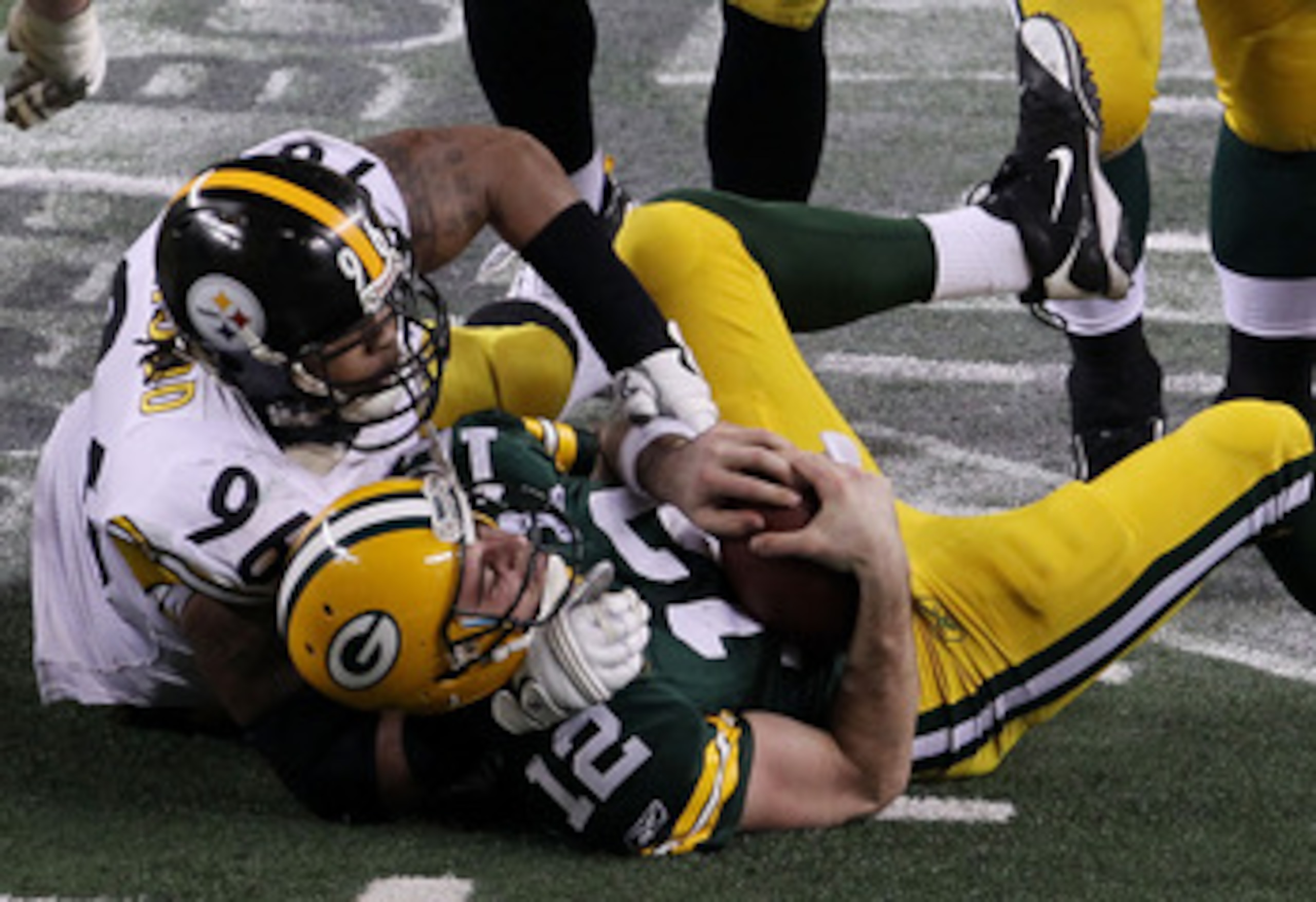 ARLINGTON, TX - FEBRUARY 06:  Aaron Rodgers #12 of the Green Bay Packers is sacked by Ziggy Hood #96 of the Pittsburgh Steelers during the fourth quarter of Super Bowl XLV at Cowboys Stadium on February 6, 2011 in Arlington, Texas.  (Photo by Jonathan Dan