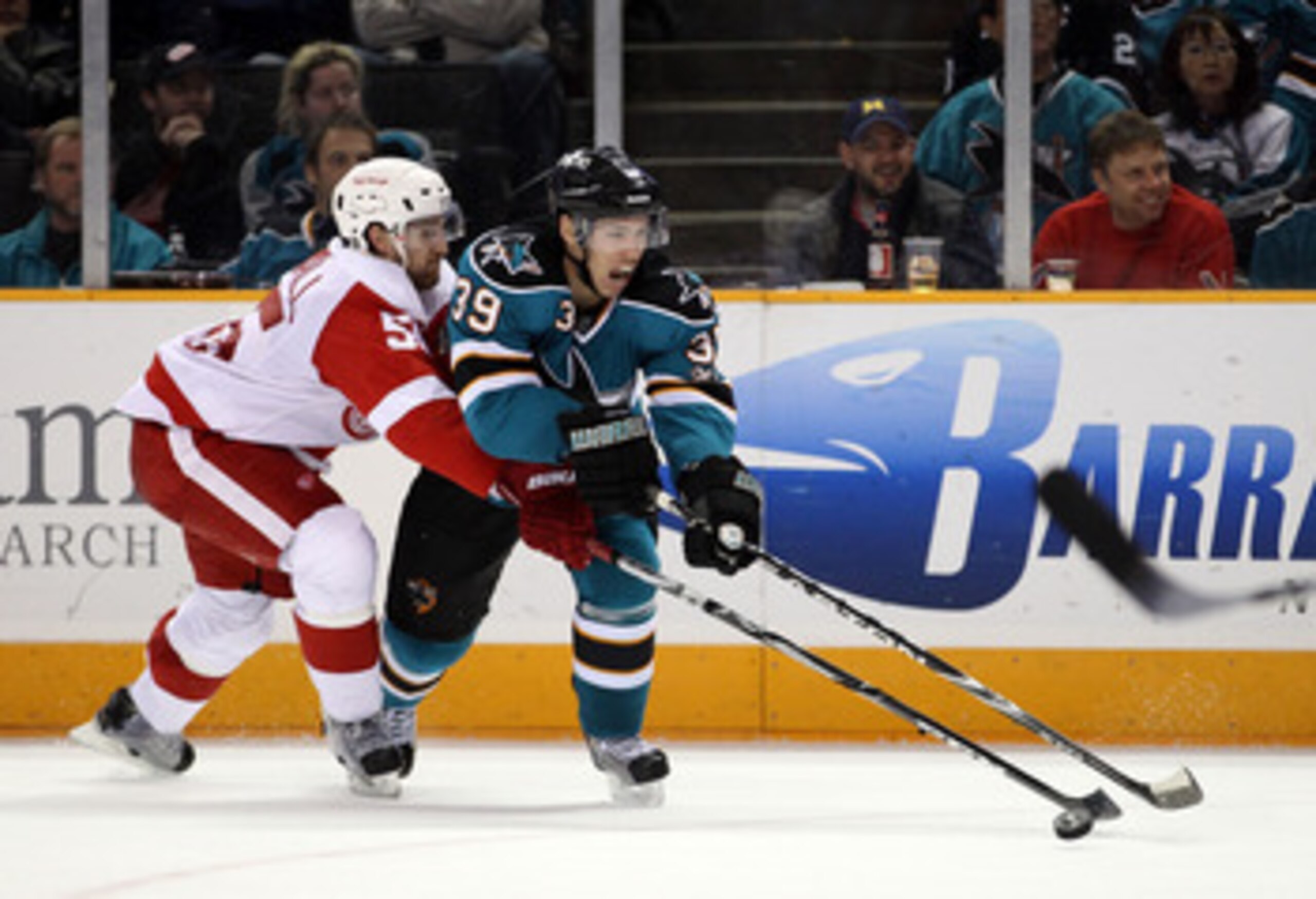 SAN JOSE, CA - NOVEMBER 30: Niklas Kronwall #55 of the Detroit Red Wings and Logan Couture #39 of the San Jose Sharks go for the puck at HP Pavilion on November 30, 2010 in San Jose, California. (Photo by Ezra Shaw/Getty Images) SAN JOSE, CA - NOVEMBER 30: Niklas Kronwall #55 of the Detroit Red Wings and Logan Couture #39 of the San Jose Sharks go for the puck at HP Pavilion on November 30, 2010 in San Jose, California. (Photo by Ezra Shaw/Getty Images)