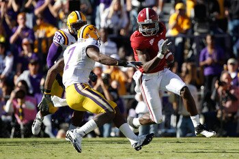 BATON ROUGE, LA - NOVEMBER 06:  Julio Jones #8 of the Alabama Crimson Tide avoids a tackle by Patrick Peterson #7 of the Louisiana State University Tigers at Tiger Stadium on November 6, 2010 in Baton Rouge, Louisiana.  The Tigers defeated the Crimson Tid