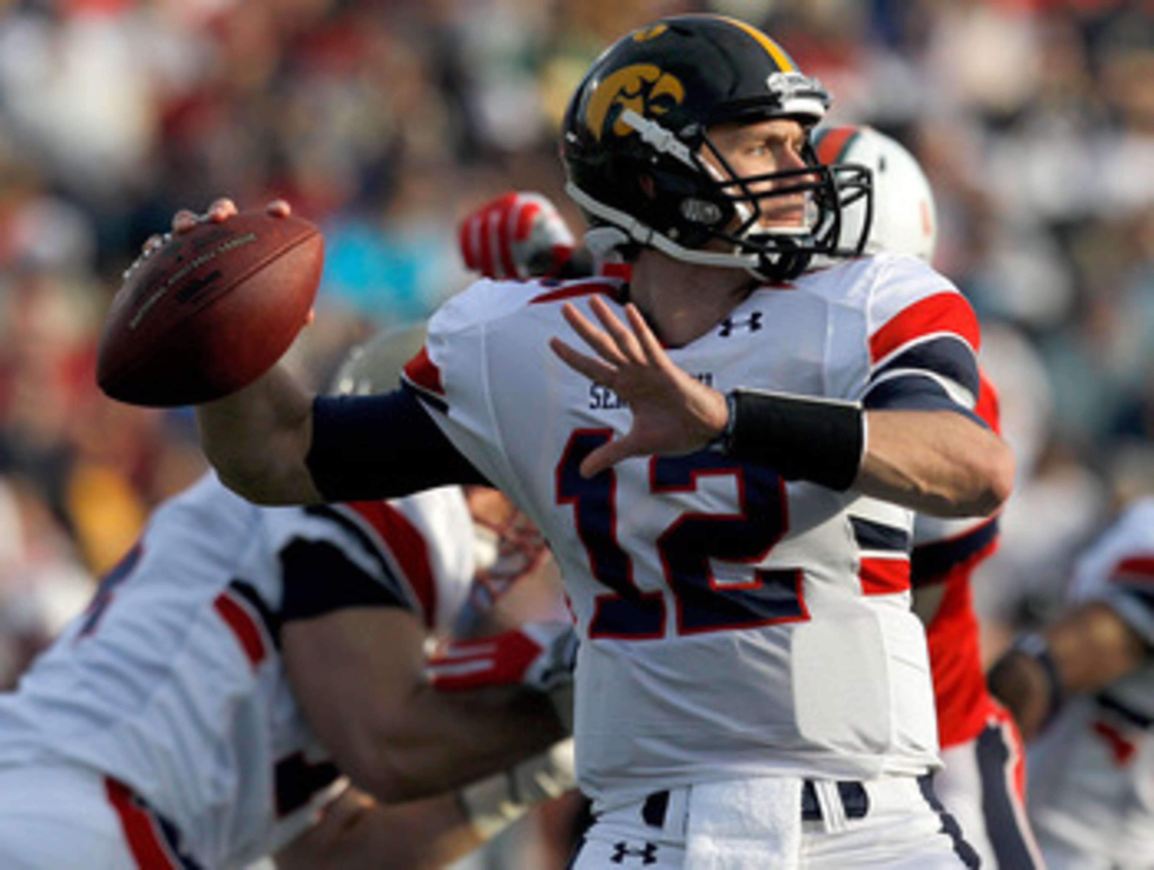 MOBILE, AL - JANUARY 29: Quarterback Ricky Stanzi #12 of the North Team passes over South Team defenders during second quarter of the Under Armour Senior Bowl on January 29, 2011 at Ladd Peebles Stadium in Mobile, Alabama. (Photo by Sean Gardner/Getty Im MOBILE, AL - JANUARY 29: Quarterback Ricky Stanzi #12 of the North Team passes over South Team defenders during second quarter of the Under Armour Senior Bowl on January 29, 2011 at Ladd Peebles Stadium in Mobile, Alabama. (Photo by Sean Gardner/Getty Im