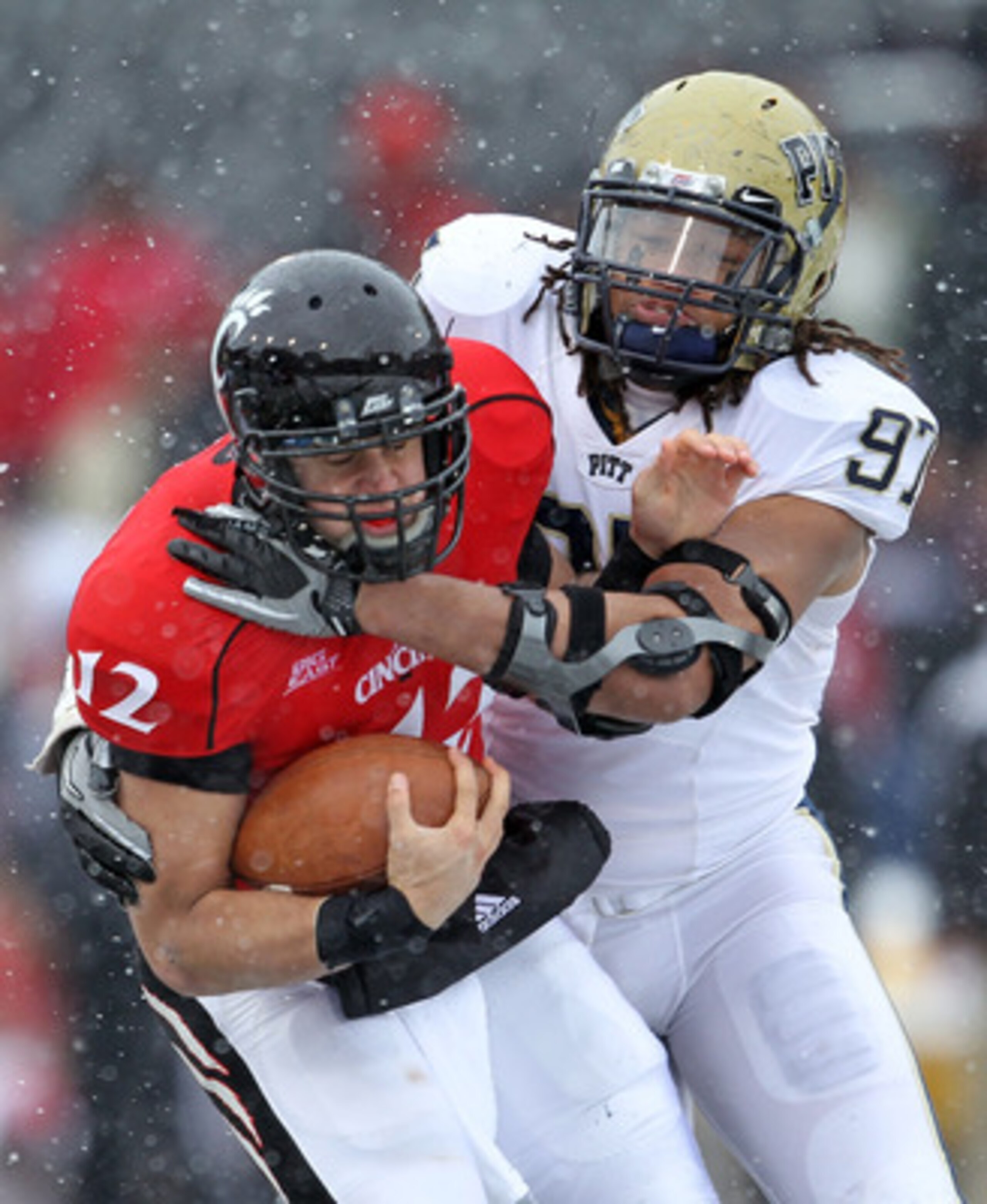 CINCINNATI, OH - DECEMBER 04: Jabaal Sheard #97 of the Pittsburgh Panthers tackles Zach Collaros #12 of the Cincinnati Bearcats during the Big East Conference game against at Nippert Stadium on December 4, 2010 in Cincinnati, Ohio. Pittsburgh won 28-10. CINCINNATI, OH - DECEMBER 04: Jabaal Sheard #97 of the Pittsburgh Panthers tackles Zach Collaros #12 of the Cincinnati Bearcats during the Big East Conference game against at Nippert Stadium on December 4, 2010 in Cincinnati, Ohio. Pittsburgh won 28-10.