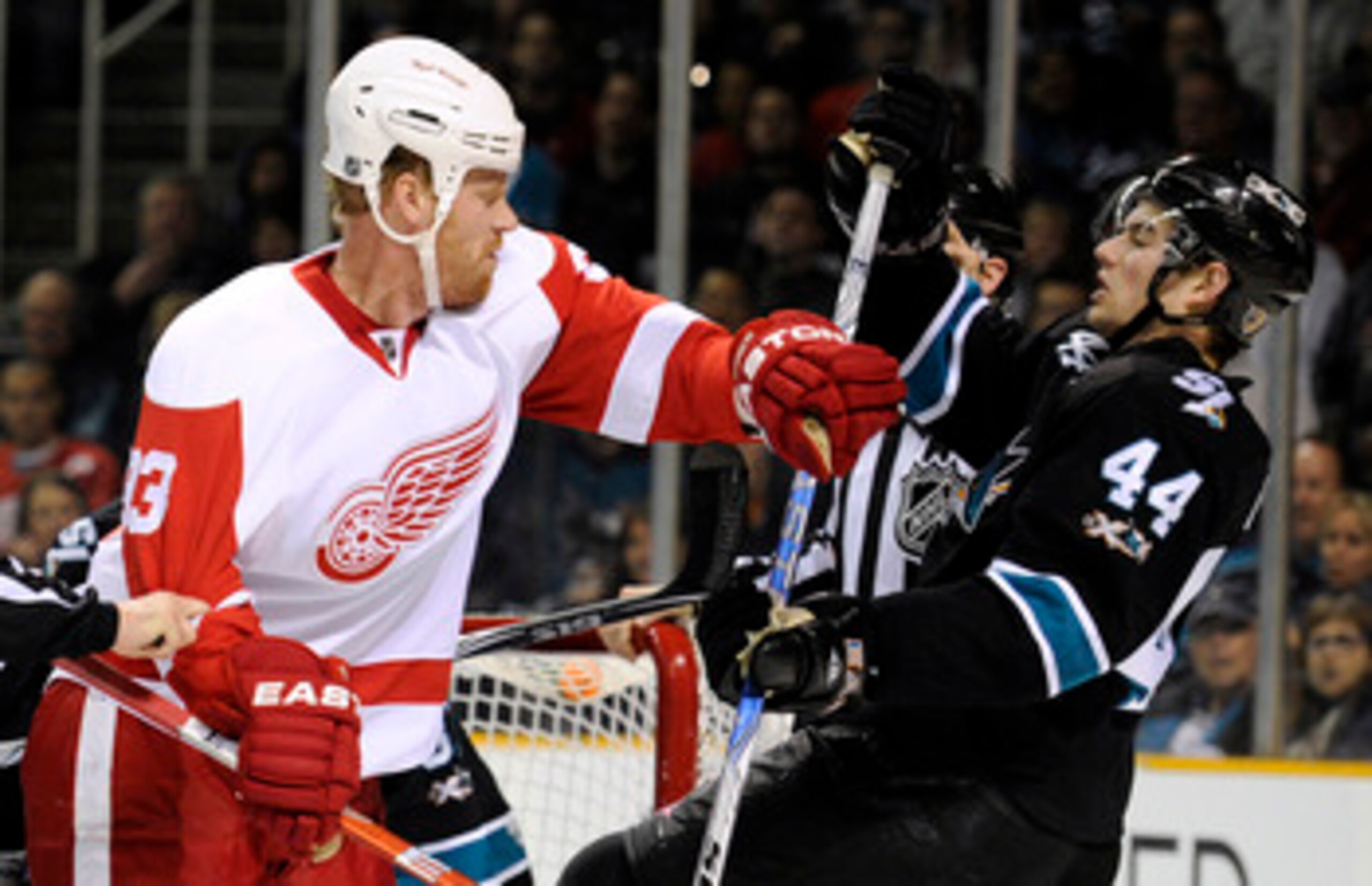 SAN JOSE, CA - MARCH 3: Johan Franzen #93 of the Detroit Red Wings takes a swing at Marc-Edouard Vlasic #44 of the San Jose Sharks and both get a four-minute roughing penalty in the first period of an NHL hockey game at the HP Pavilion on March 3, 2011 in