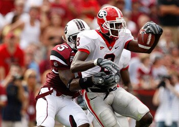 COLUMBIA, SC - SEPTEMBER 13:  A.J. Green #8 of the Georgia Bulldogs tries to break a tackle by Carlos Thomas #5 of the South Carolina Gamecocks during their game September 13, 2008 at Williams-Brice Stadium in Columbia, South Carolina.  (Photo by Streeter