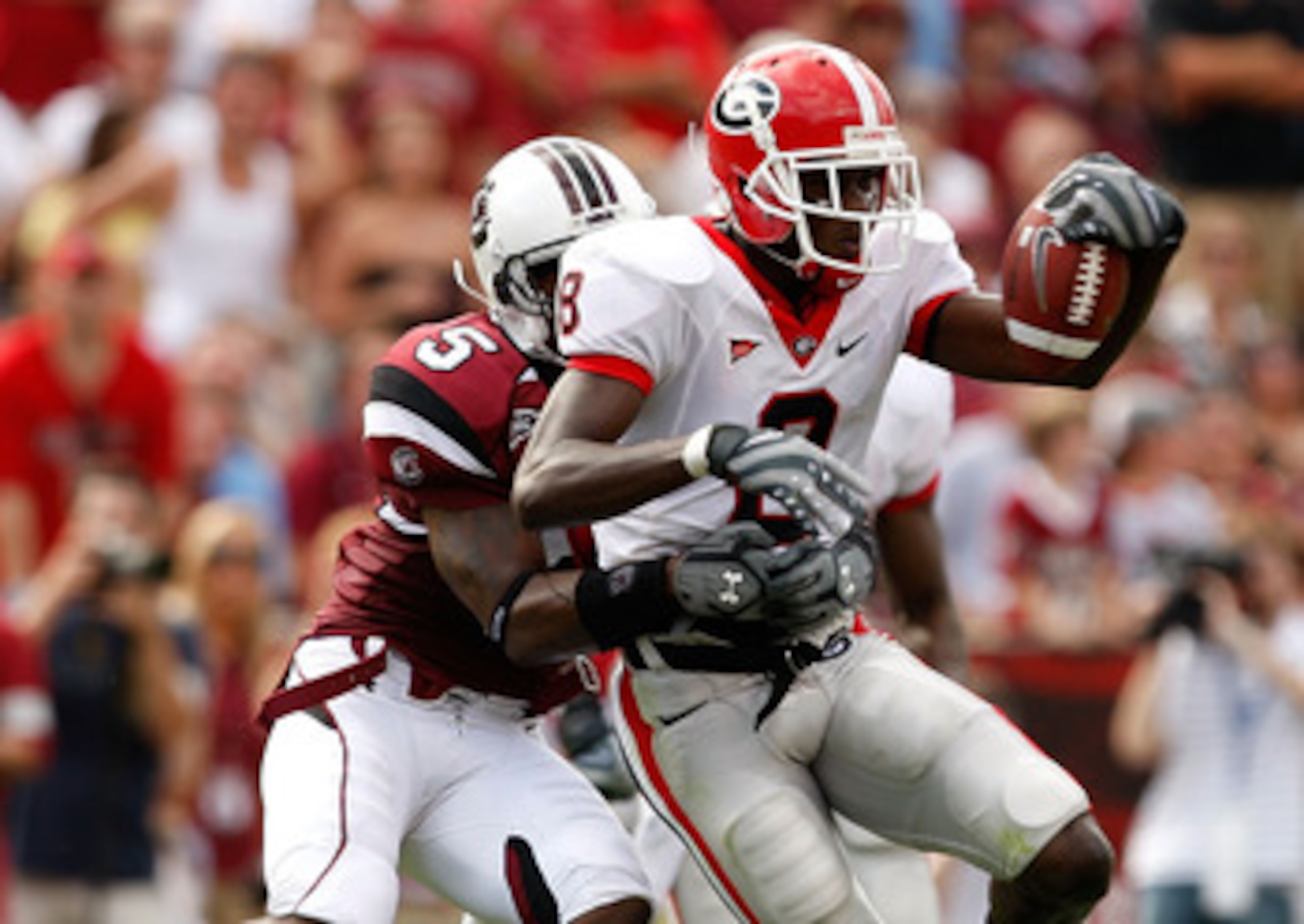COLUMBIA, SC - SEPTEMBER 13:  A.J. Green #8 of the Georgia Bulldogs tries to break a tackle by Carlos Thomas #5 of the South Carolina Gamecocks during their game September 13, 2008 at Williams-Brice Stadium in Columbia, South Carolina.  (Photo by Streeter
