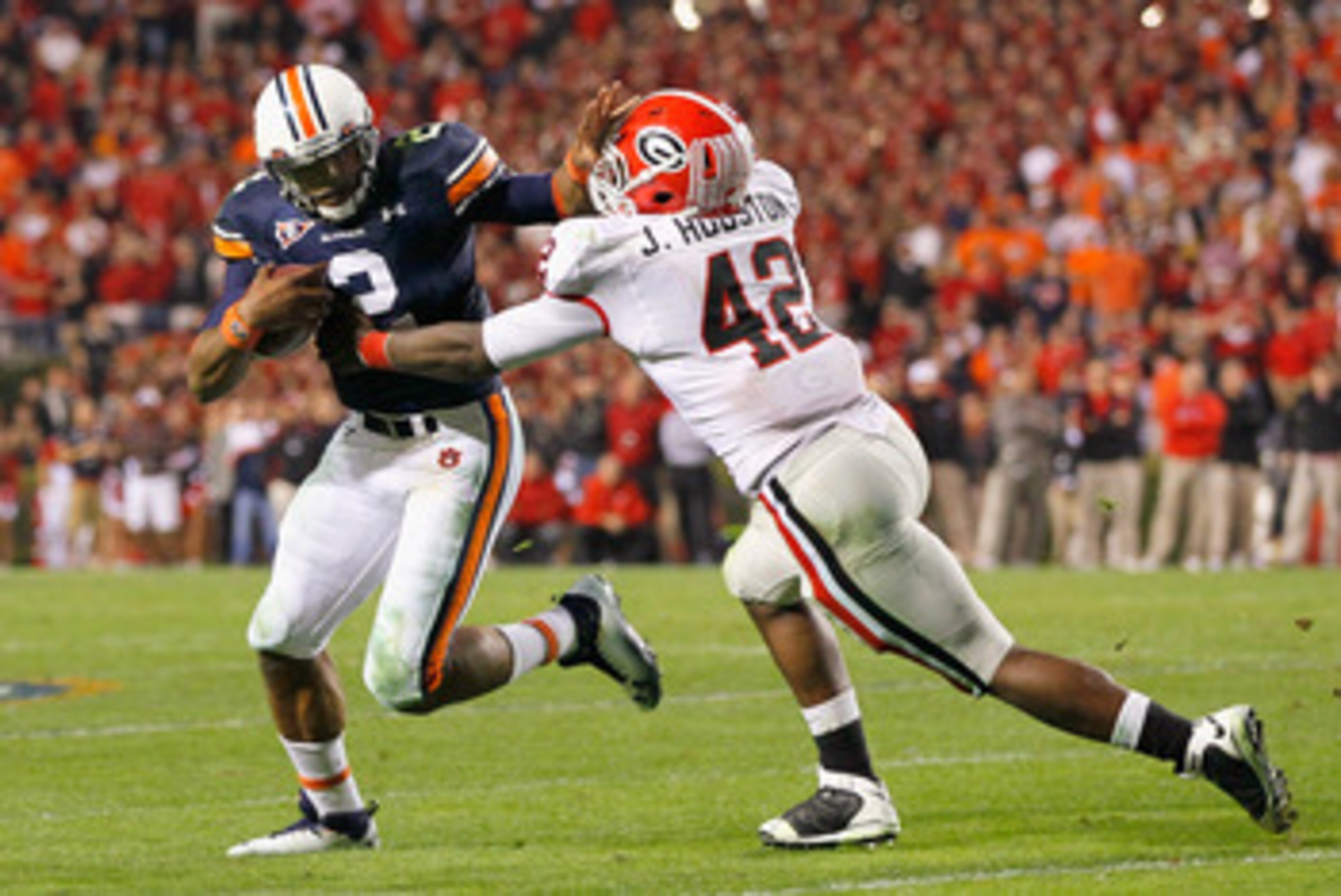 AUBURN, AL - NOVEMBER 13: Quarterback Cameron Newton #2 of the Auburn Tigers breaks a tackle by Justin Houston #42 of the Georgia Bulldogs at Jordan-Hare Stadium on November 13, 2010 in Auburn, Alabama. (Photo by Kevin C. Cox/Getty Images) AUBURN, AL - NOVEMBER 13: Quarterback Cameron Newton #2 of the Auburn Tigers breaks a tackle by Justin Houston #42 of the Georgia Bulldogs at Jordan-Hare Stadium on November 13, 2010 in Auburn, Alabama. (Photo by Kevin C. Cox/Getty Images)