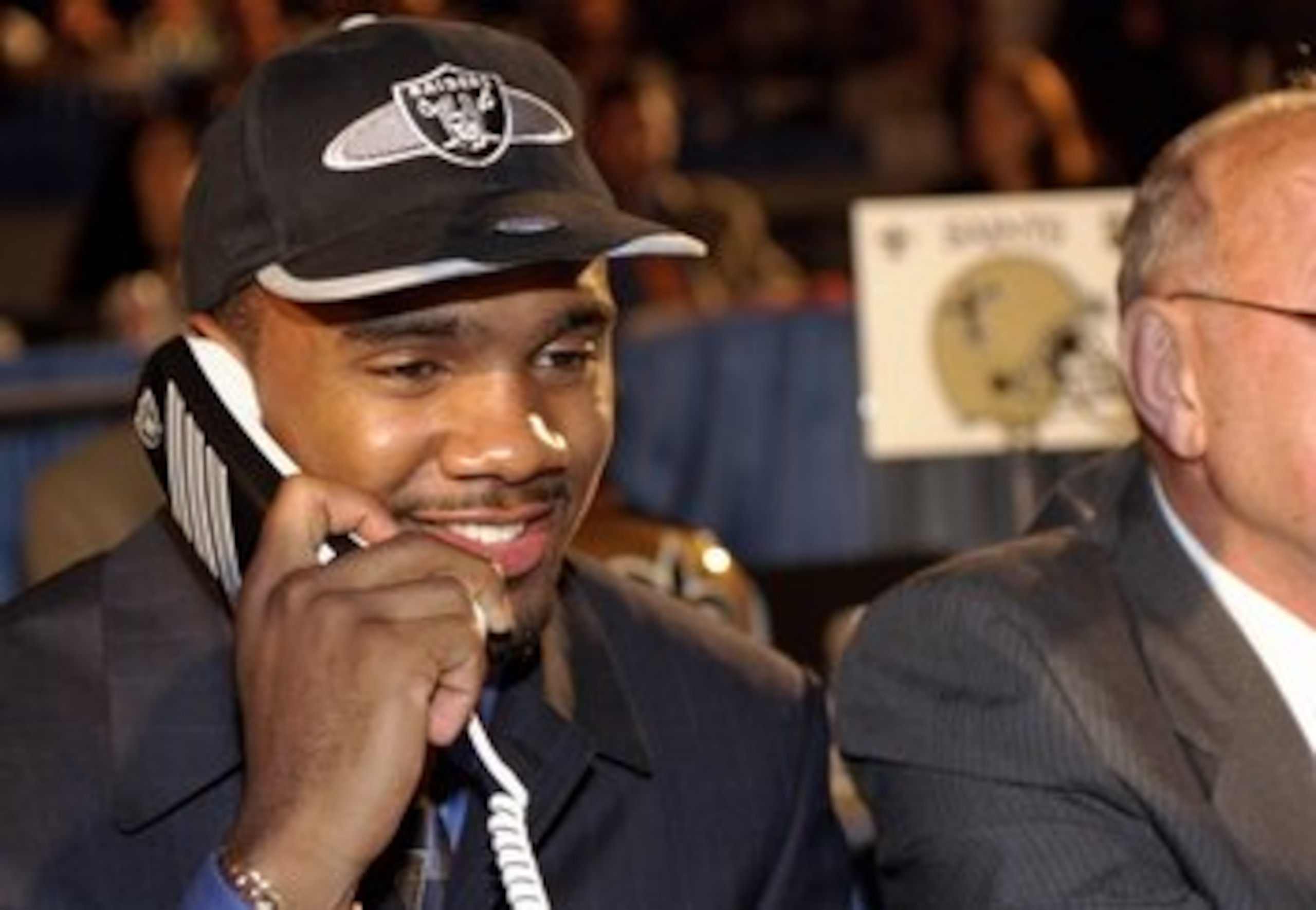 18 Apr 1998: Fourth overall pick Charles Woodson talks on the phone after being selected by the Oakland Raiders in the first round of the 1998 NFL Draft at Madison Square Garden in Manhattan, New York. Mandatory Credit: Ezra C. Shaw /Allsport 18 Apr 1998: Fourth overall pick Charles Woodson talks on the phone after being selected by the Oakland Raiders in the first round of the 1998 NFL Draft at Madison Square Garden in Manhattan, New York. Mandatory Credit: Ezra C. Shaw /Allsport