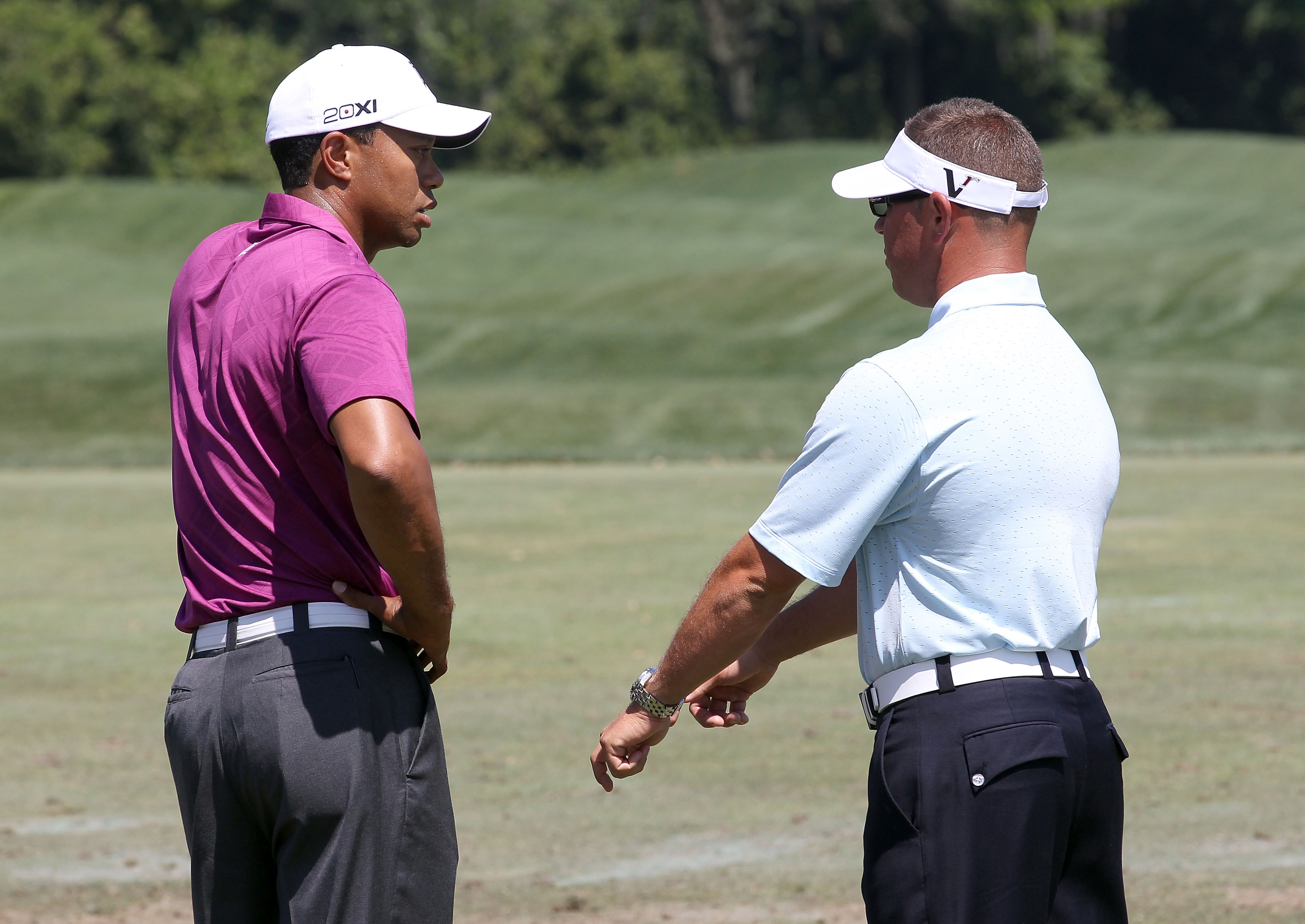 ORLANDO, FL - MARCH 26:  Tiger Woods (L) speaks with swing coach Sean Foley prior to the third round of the Arnold Palmer Invitational presented by MasterCard at the Bay Hill Club and Lodge on March 26, 2011 in Orlando, Florida.  (Photo by Sam Greenwood/G