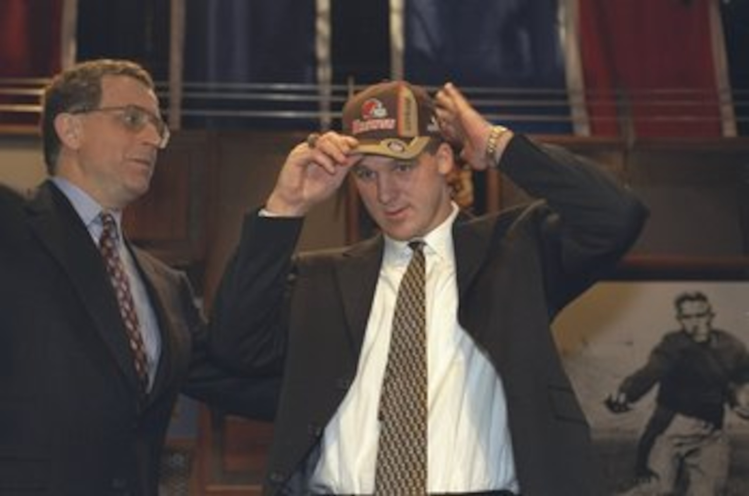 17 Apr 1999: Paul Tagliabue helps Tim Couch the number one draft pick with his hat during the NFL Draft at the Madison Square Garden in New York, New York. 17 Apr 1999: Paul Tagliabue helps Tim Couch the number one draft pick with his hat during the NFL Draft at the Madison Square Garden in New York, New York.