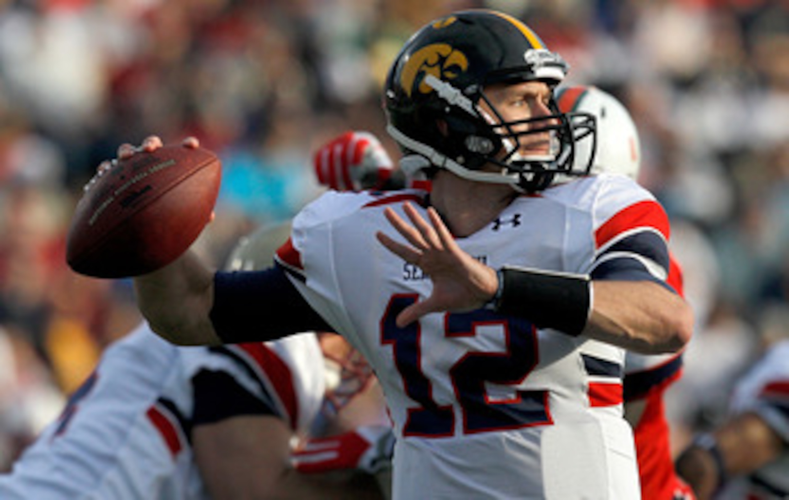 MOBILE, AL - JANUARY 29: Quarterback Ricky Stanzi #12 of the North Team passes over South Team defenders during second quarter of the Under Armour Senior Bowl on January 29, 2011 at Ladd Peebles Stadium in Mobile, Alabama.  (Photo by Sean Gardner/Getty Im