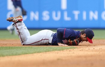NEW YORK, NY - APRIL 07: Tsuyoshi Nishioka #1 of the Minnesota Twins lays injured after being hit by Nick Swisher #33 of the New York Yankees at Yankee Stadium on April 7, 2011 in the Bronx borough of New York City.  (Photo by Nick Laham/Getty Images)