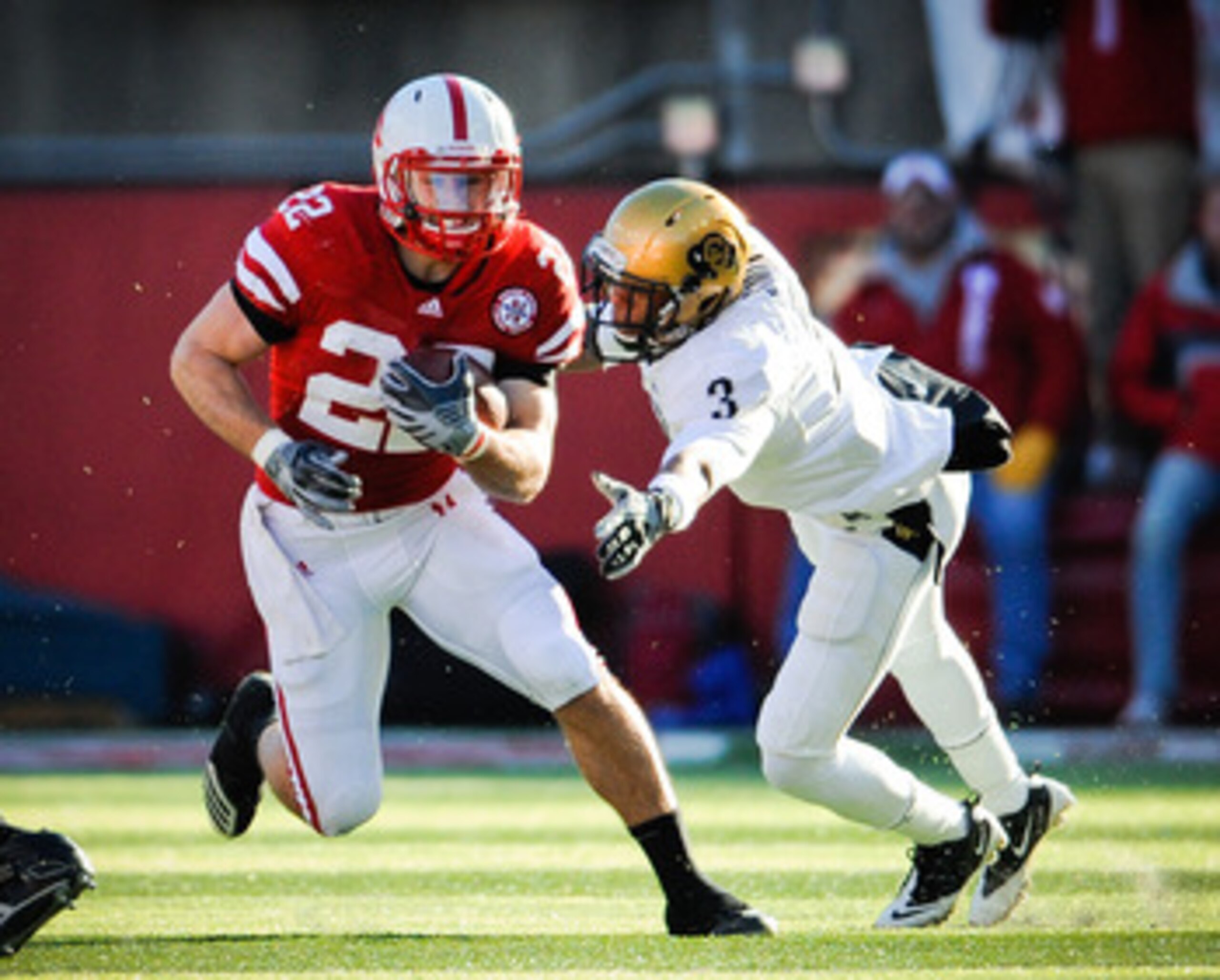 LINCOLN, NE - NOVEMBER 26: Rex Burkhead #22 of the Nebraska Cornhuskers slips past Jimmy Smith #3 of the Colorado Buffaloes during their game at Memorial Stadium on November 26, 2010 in Lincoln, Nebraska. Nebraska defeated Colorado 45-17 (Photo by Eric Fr LINCOLN, NE - NOVEMBER 26: Rex Burkhead #22 of the Nebraska Cornhuskers slips past Jimmy Smith #3 of the Colorado Buffaloes during their game at Memorial Stadium on November 26, 2010 in Lincoln, Nebraska. Nebraska defeated Colorado 45-17 (Photo by Eric Fr