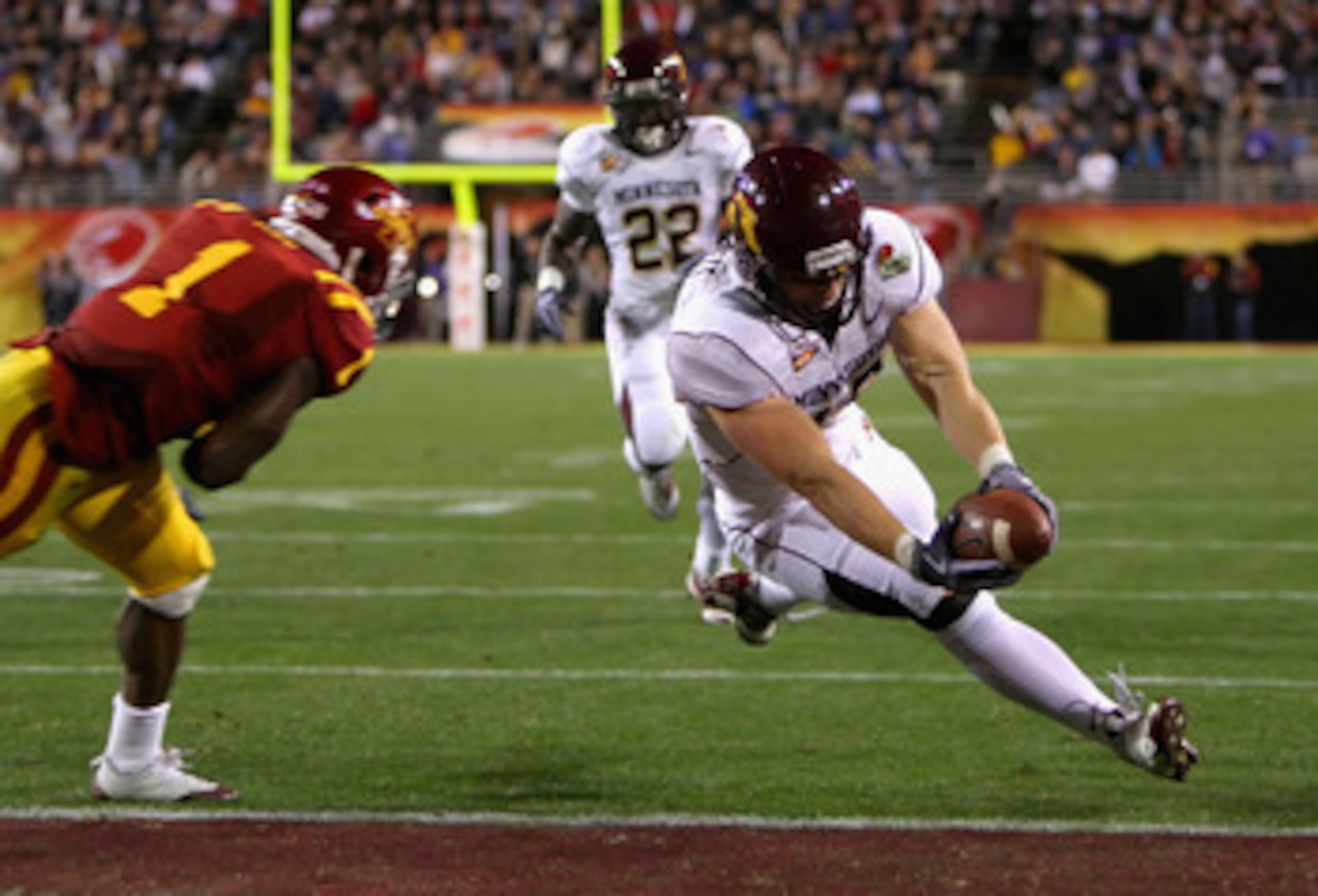 TEMPE, AZ - DECEMBER 31:  Tight end Nick Tow-Arnett #48 of the Minnesota Golden Gophers dives into the endzone to score on a 23 yard reception past David Sims #1 of the Iowa State Cyclones during the Insight Bowl at Arizona Stadium on December 31, 2009 in