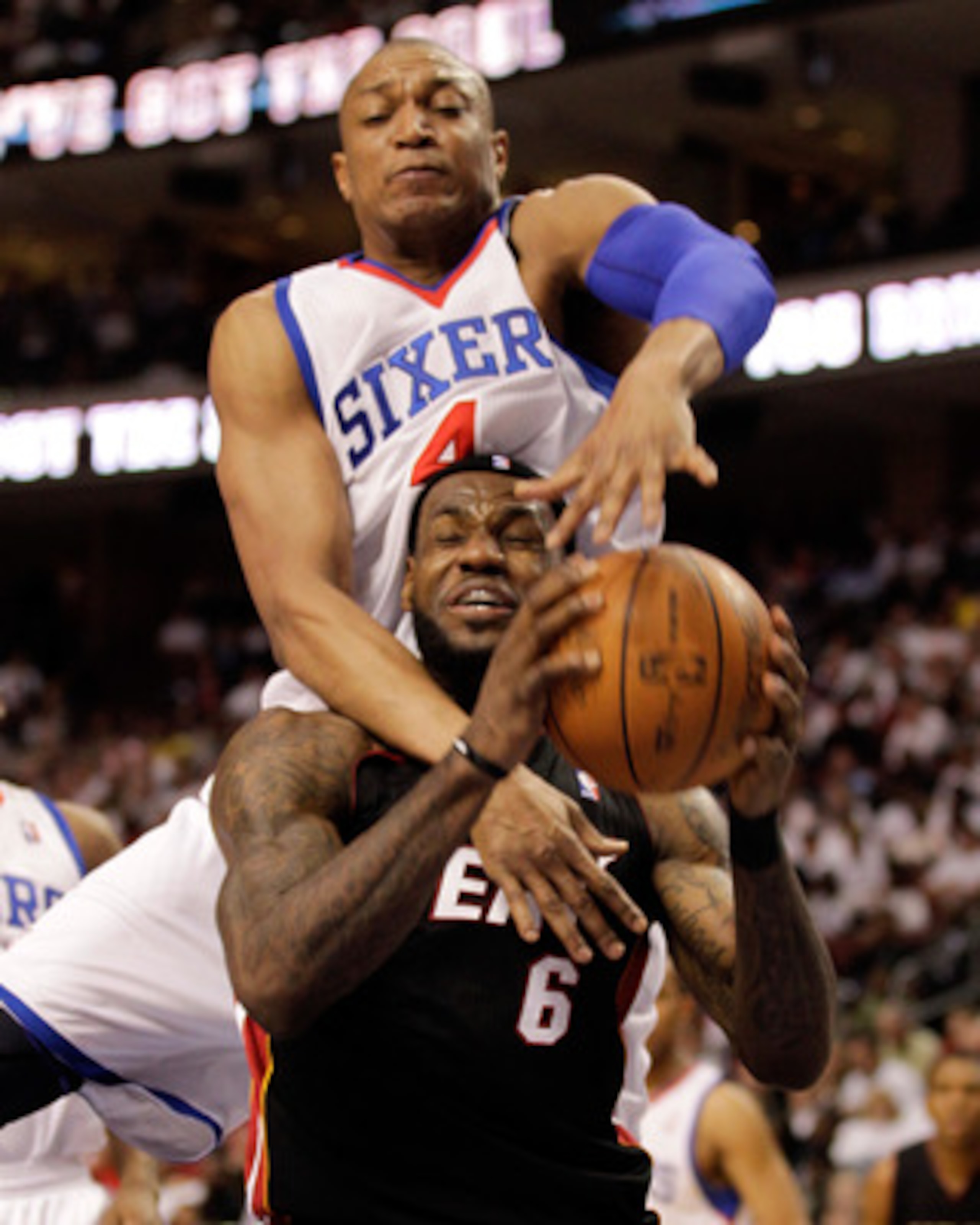 PHILADELPHIA, PA - APRIL 21: LeBron James #6 of the Miami Heat is fouled by Tony Battie #4 of the Philadelphia 76ers during the first half of game three of the Eastern Conference Quarterfinals at Wells Fargo Center on April 21, 2011 in Philadelphia, Penns