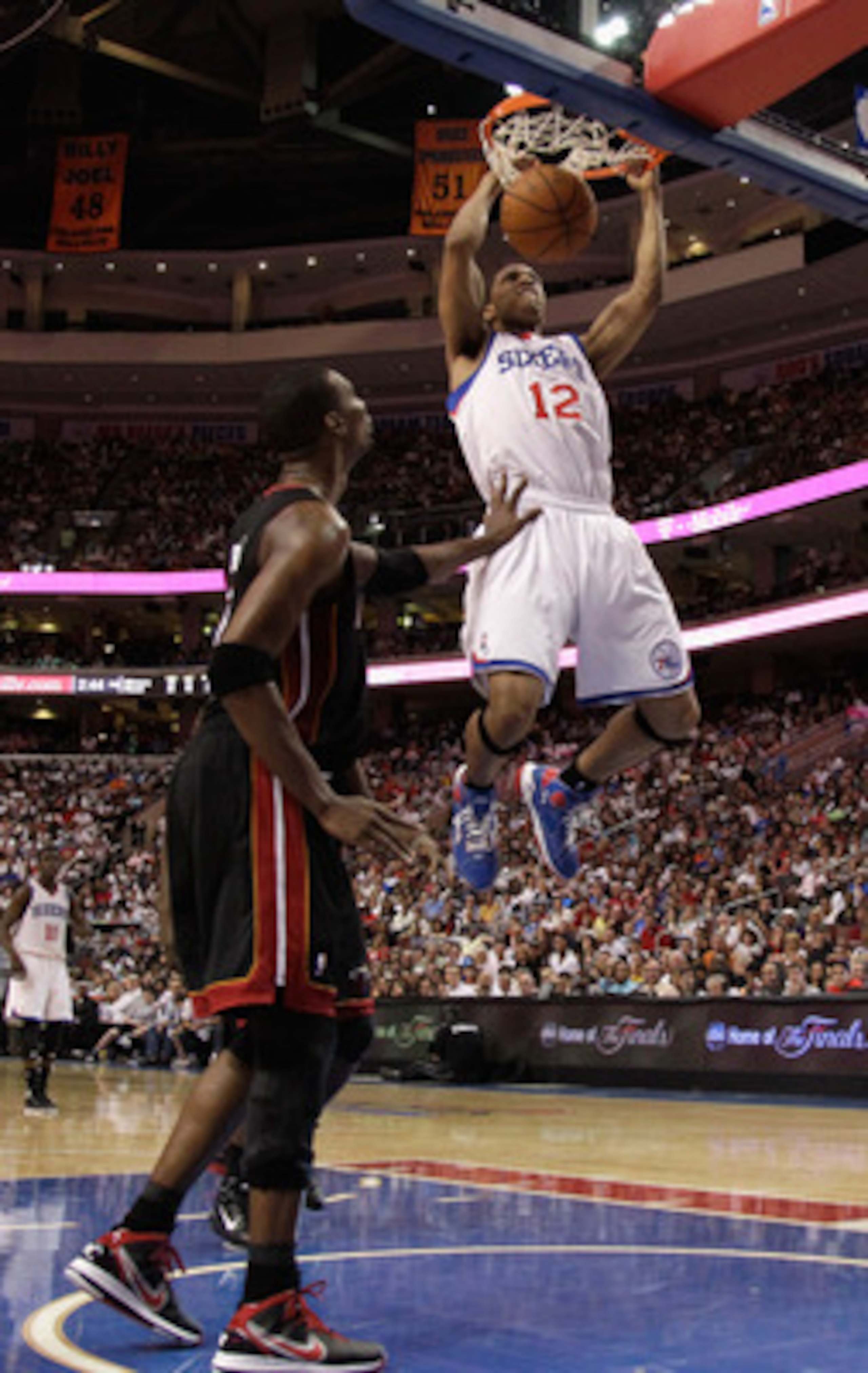PHILADELPHIA, PA - APRIL 24: Evan Turner #12 of the Philadelphia 76ers dunks in front of Chris Bosh #1 of the Miami Heat during the second half of Game Four of the Eastern Conference Quarterfinals in the 2011 NBA Playoffs at Wells Fargo Center on April 24