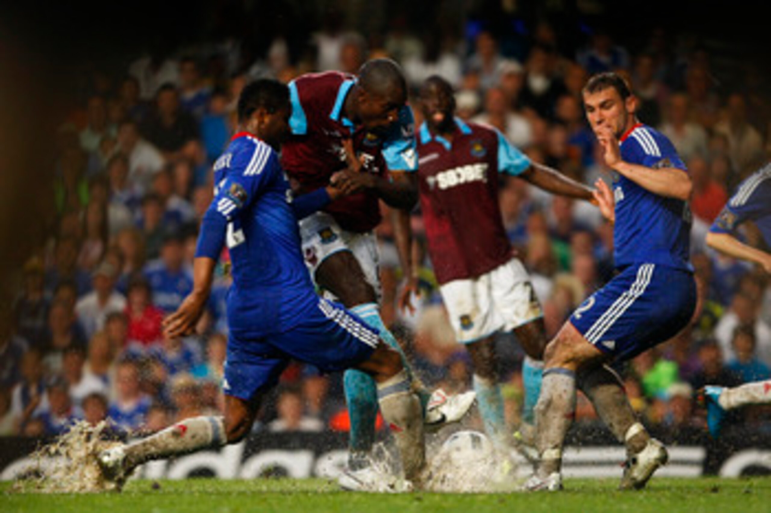 LONDON, ENGLAND - APRIL 23:  Carlton Cole (C) of West Ham shoots in between John Obi Mikel (L) and Branislav Ivanovic of Chelsea during the Barclays Premier League match between Chelsea and West Ham United at Stamford Bridge on April 23, 2011 in London, E