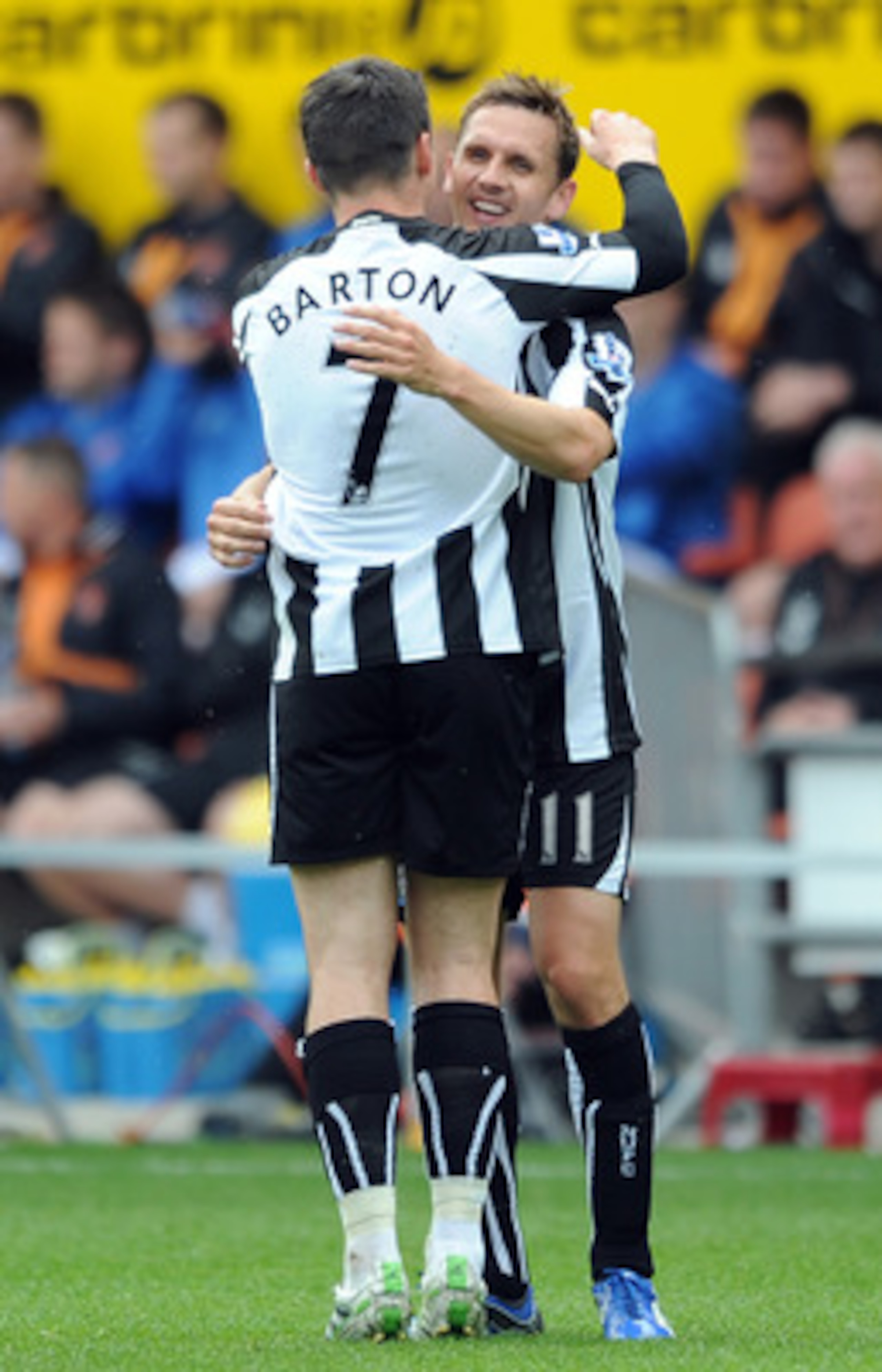 BLACKPOOL, ENGLAND - APRIL 23:  Peter Lovenkrands of Newcastle United is congratulated by team-mate Joey Barton after scoring the opening goal during the Barclays Premier League match between Blackpool and Newcastle United at Bloomfield Road on April 23, 