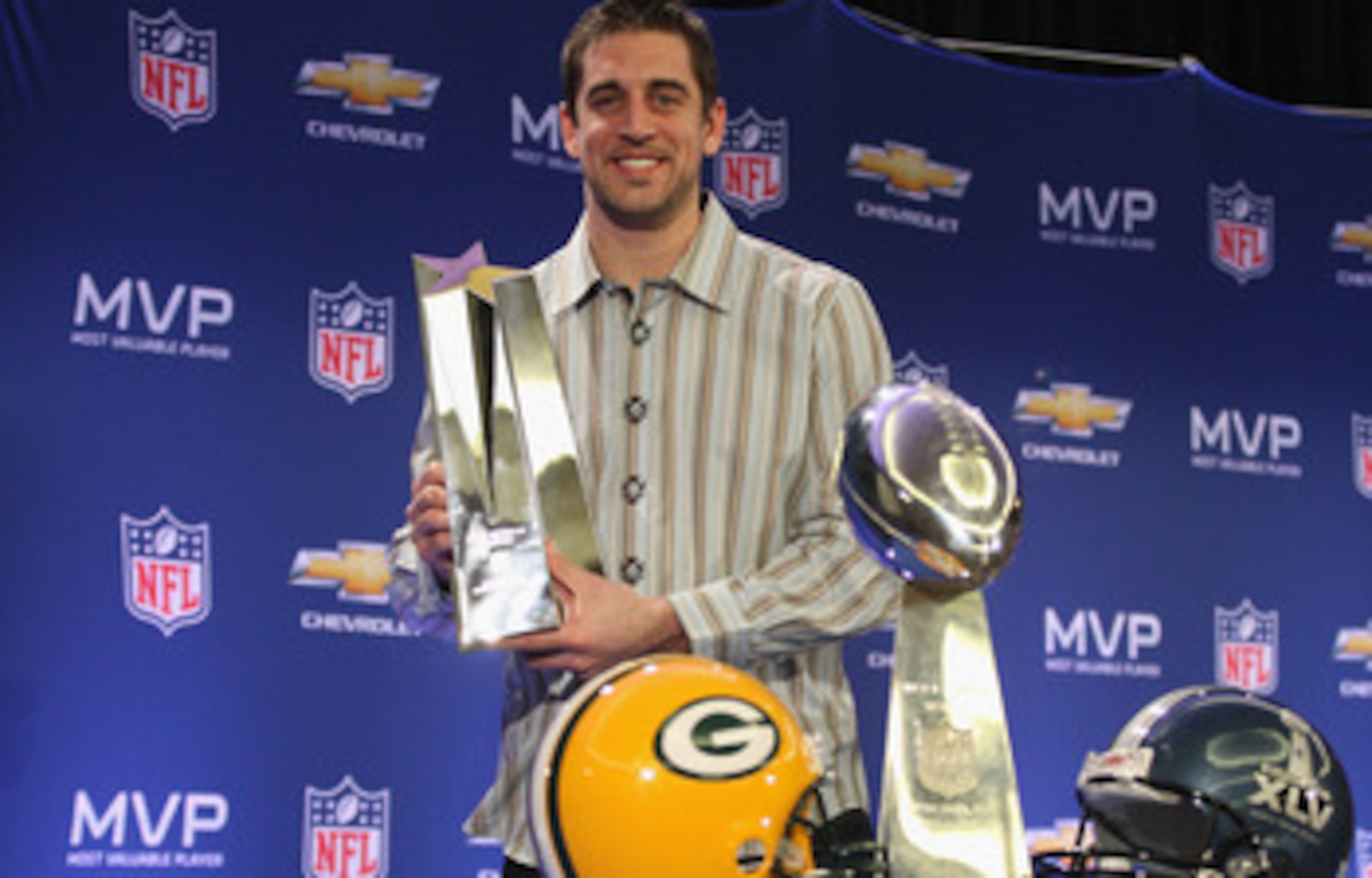 DALLAS, TX - FEBRUARY 07: Green Bay Packers quarterback Aaron Rodgers poses with the MVP trophy after speaking to the media during a press conference at Super Bowl XLV Media Center on February 7, 2011 in Dallas, Texas. (Photo by Streeter Lecka/Getty Ima DALLAS, TX - FEBRUARY 07: Green Bay Packers quarterback Aaron Rodgers poses with the MVP trophy after speaking to the media during a press conference at Super Bowl XLV Media Center on February 7, 2011 in Dallas, Texas. (Photo by Streeter Lecka/Getty Ima