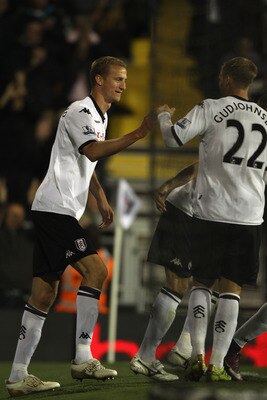 LONDON, ENGLAND - APRIL 27:  Brede Hangeland (L) of Fulham celebrates scoring his sides third goal with Eidur Gudjohnsen during the Barclays Premier League match between Fulham and Bolton Wanderers at Craven Cottage on April 27, 2011 in London, England.  