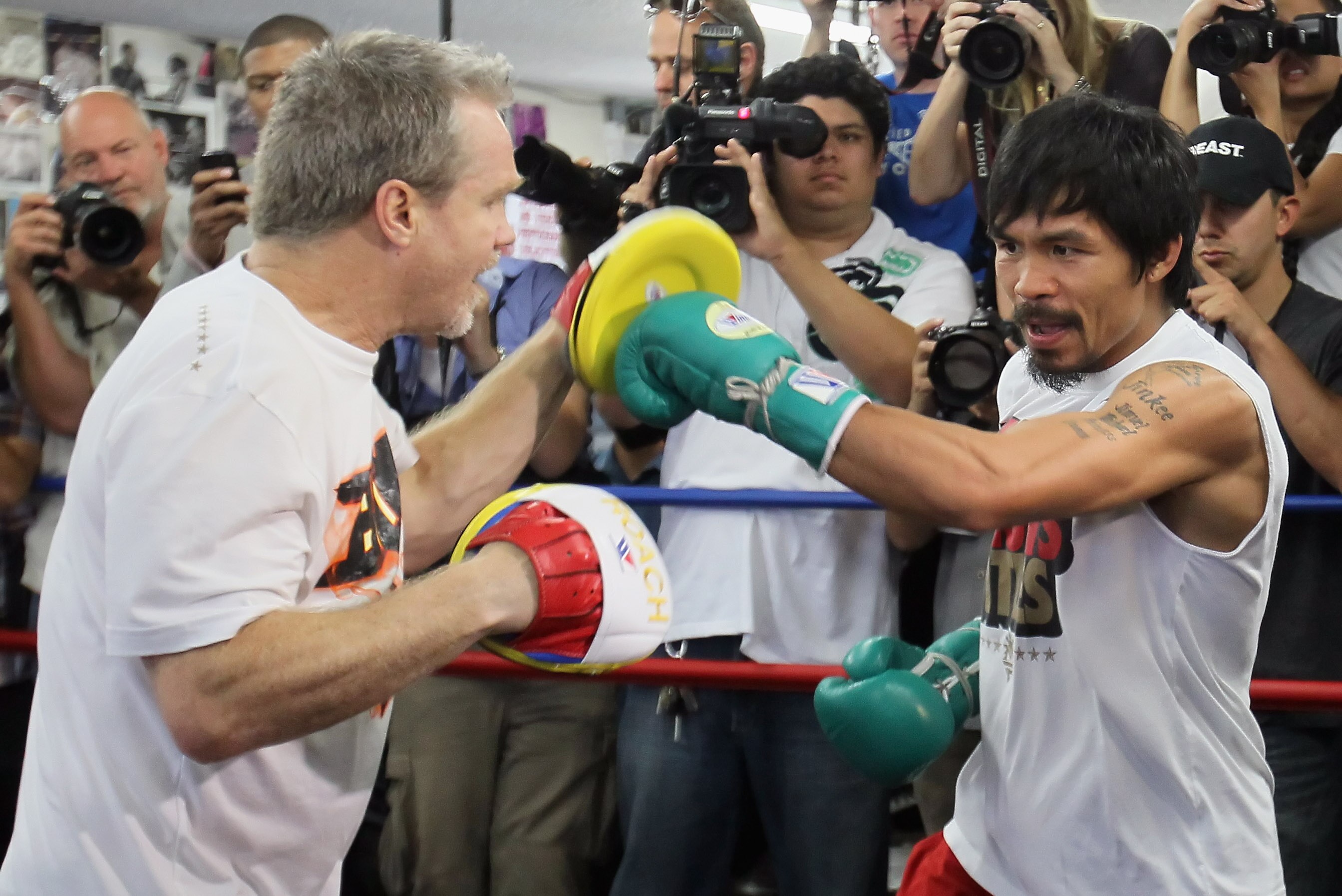 HOLLYWOOD, CA - APRIL 20:  Manny Pacquiao (R) of the Philippines spars with his coach Freddie Roach (L) during a media workout at the Wild Card Boxing Club on April 20, 2011 in Hollywood, California.  (Photo by Jeff Gross/Getty Images)