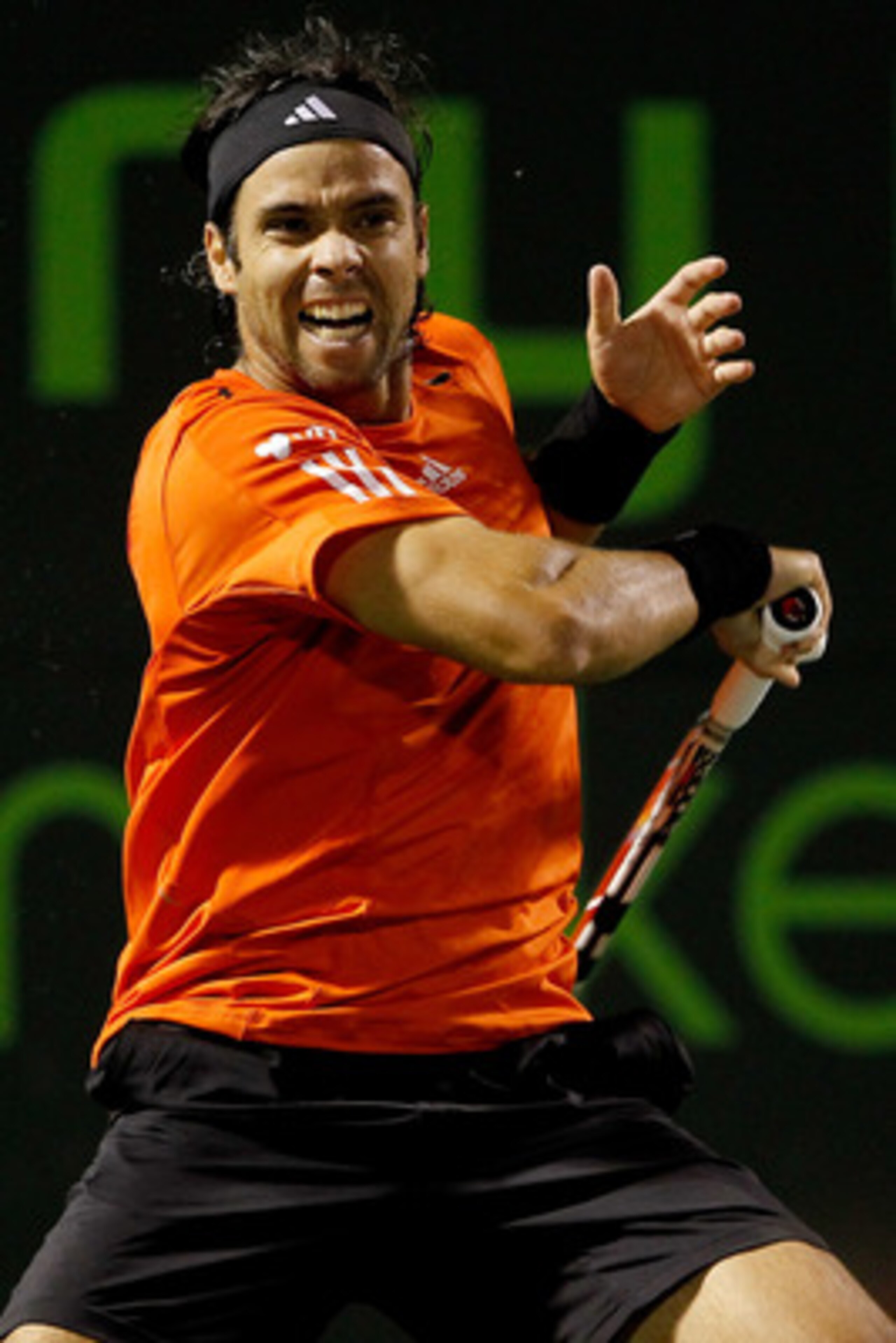 KEY BISCAYNE, FL - MARCH 29:  Fernando Gonzalez of Chile returns a shot to Juan Monaco of Argentina during day seven of the 2010 Sony Ericsson Open at Crandon Park Tennis Center on March 29, 2010 in Key Biscayne, Florida.  (Photo by Matthew Stockman/Getty