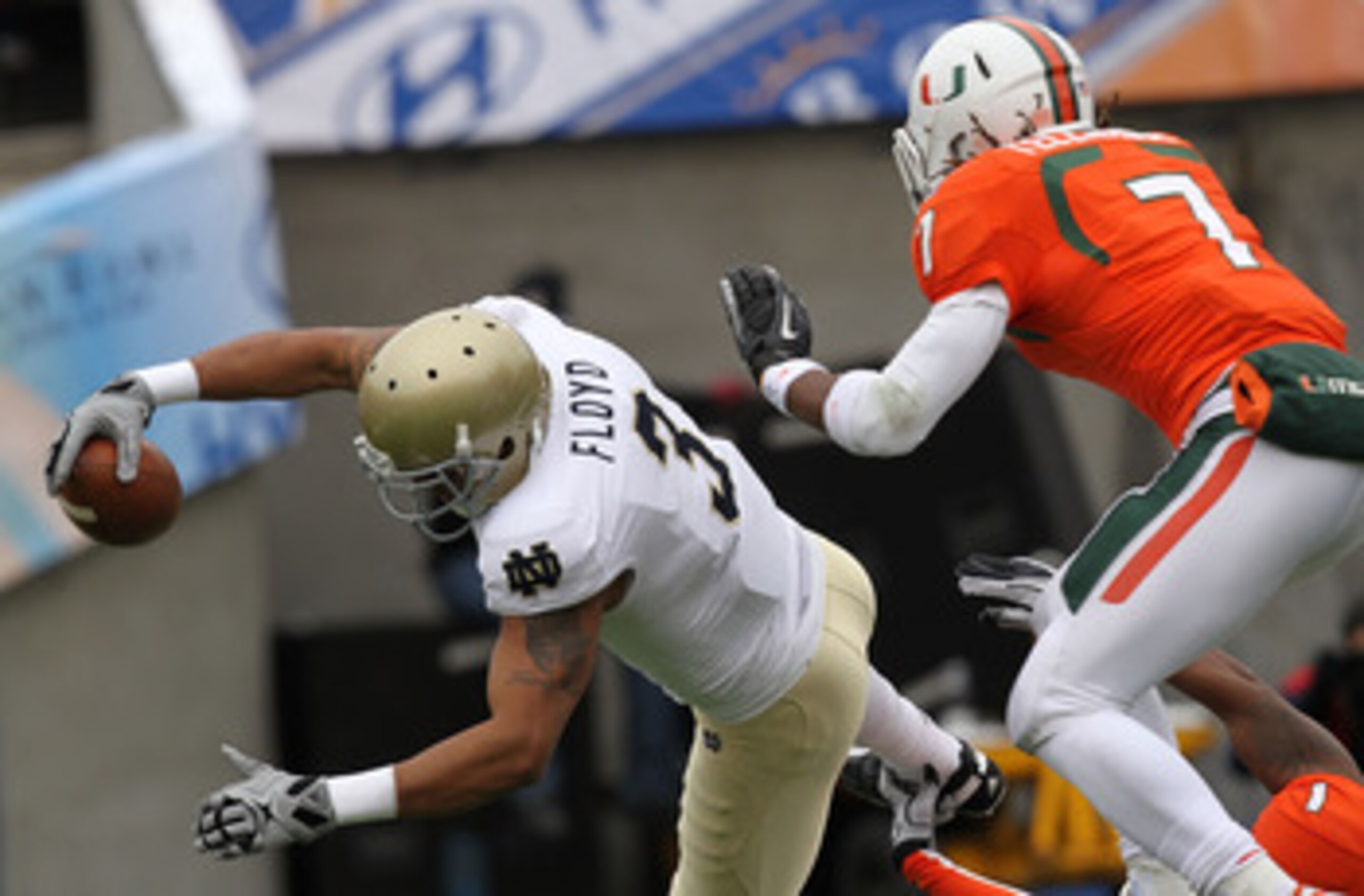EL PASO, TX - DECEMBER 30:  Wide receiver Michael Floyd #3 of the Notre Dame Fighting Irish dives for a touchdown against Vaughn Telemaque #7 of the Miami Hurricanes at Sun Bowl on December 30, 2010 in El Paso, Texas.  (Photo by Ronald Martinez/Getty Imag