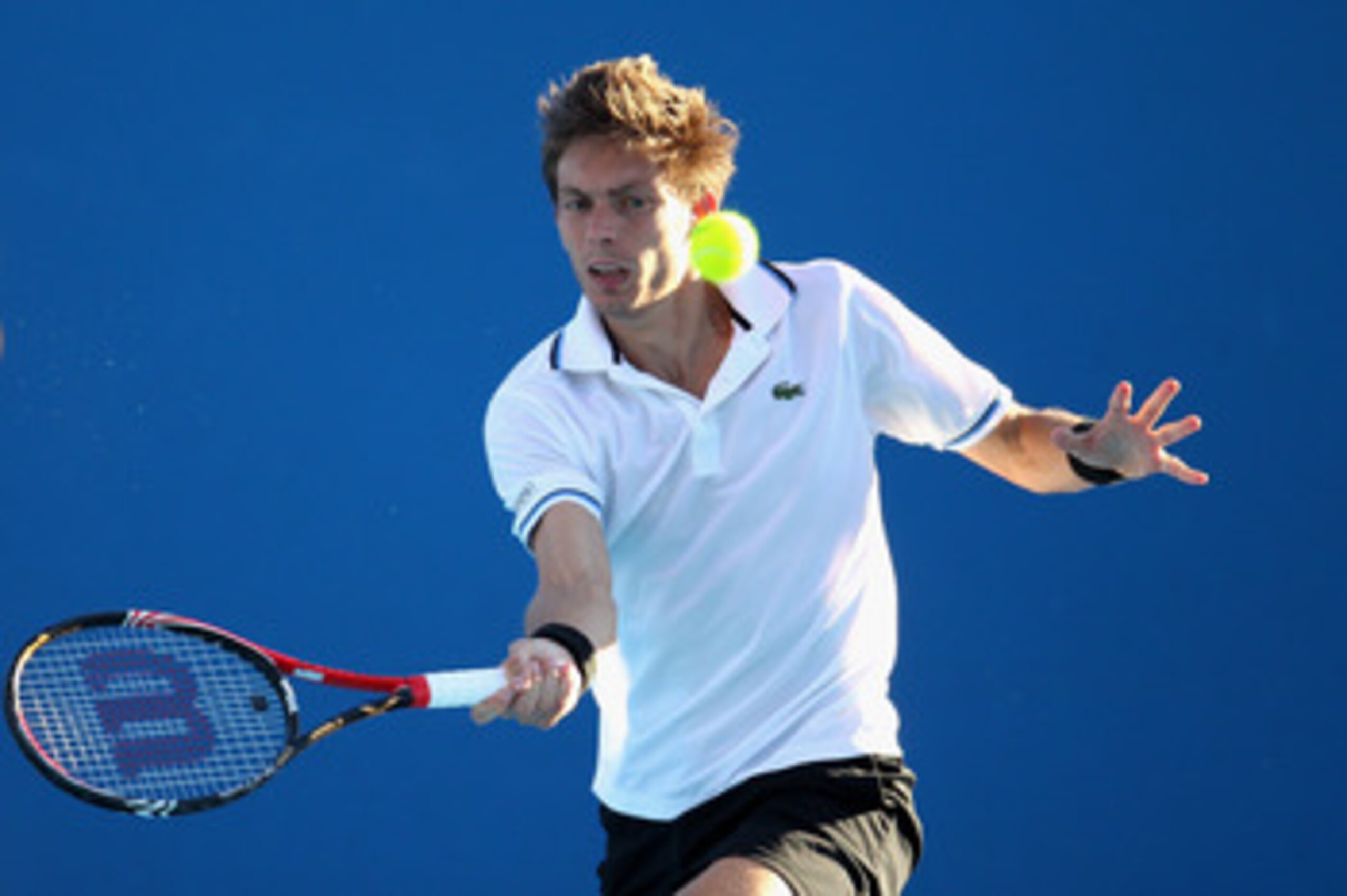 MELBOURNE, AUSTRALIA - JANUARY 19:  Nicolas Mahut of France plays a forehand during his second round match against Viktor Troicki of Serbia during day three of the 2011 Australian Open at Melbourne Park on January 19, 2011 in Melbourne, Australia.  (Photo