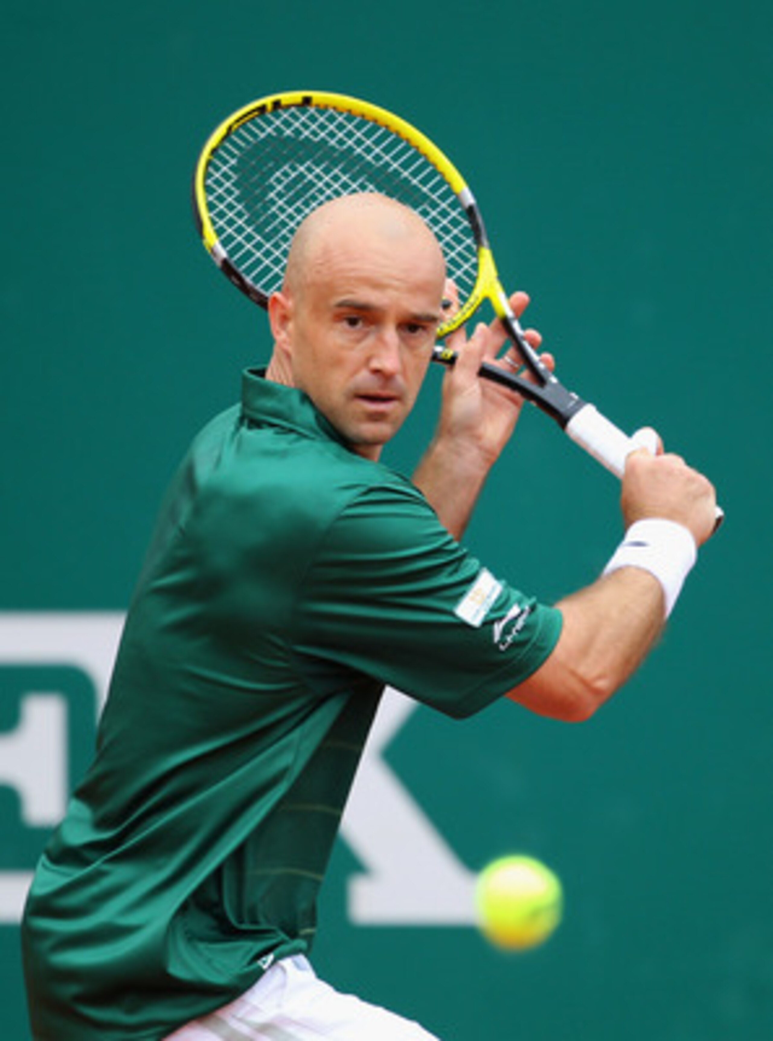 MONACO - APRIL 14:  Ivan Ljubicic of Croatia plays a backhand in his match against Tomas Berdych of Czech Republic in action against  during Day Five of the ATP Masters Series Tennis at the Monte Carlo Country Club on April 14, 2011 in Monte Carlo, Monaco