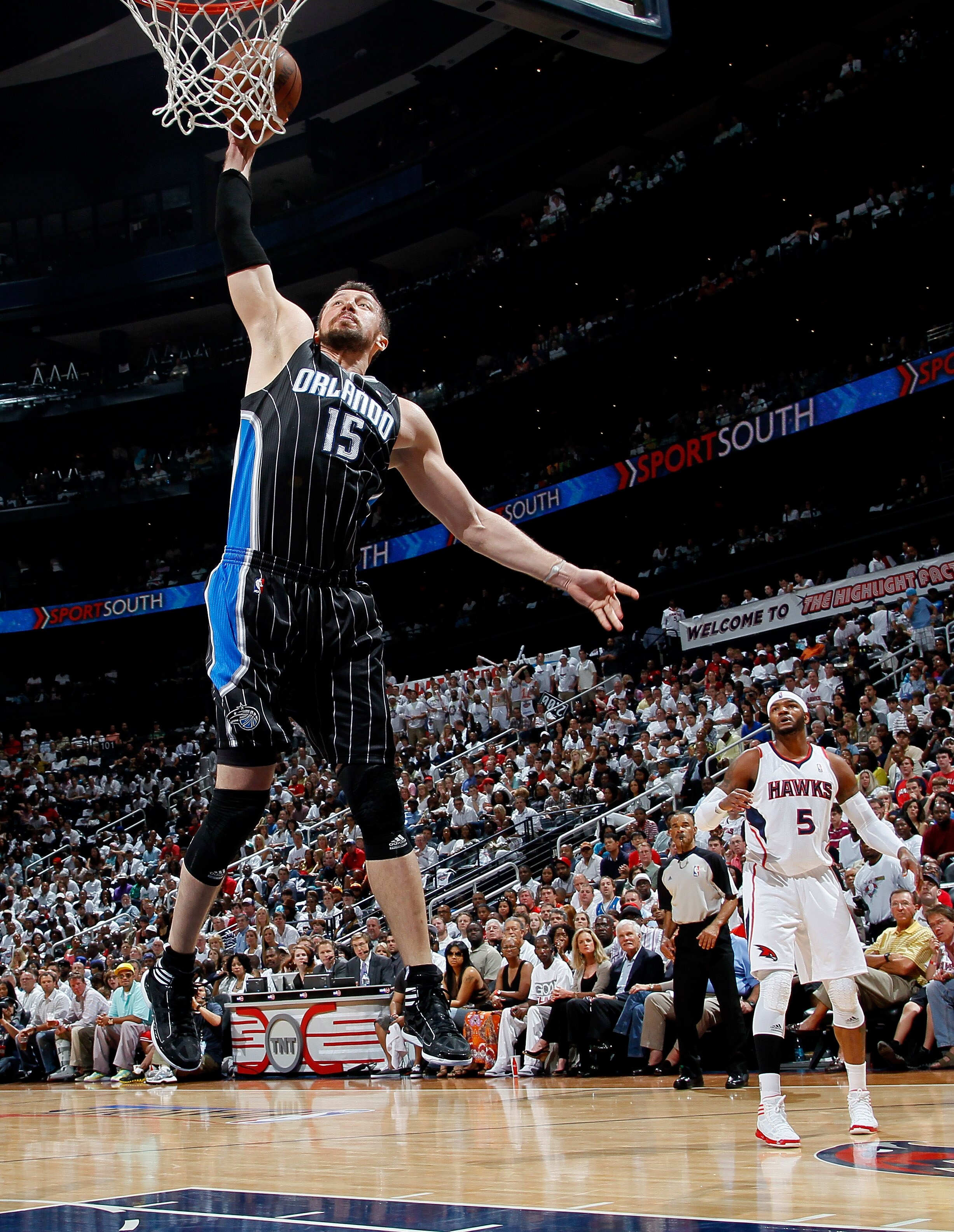 ATLANTA, GA - APRIL 24:  Hedo Turkoglu #15 of the Orlando Magic dunks past Josh Smith #5 of the Atlanta Hawks during Game Four of the Eastern Conference Quarterfinals in the 2011 NBA Playoffs at Philips Arena on April 24, 2011 in Atlanta, Georgia.  NOTE T