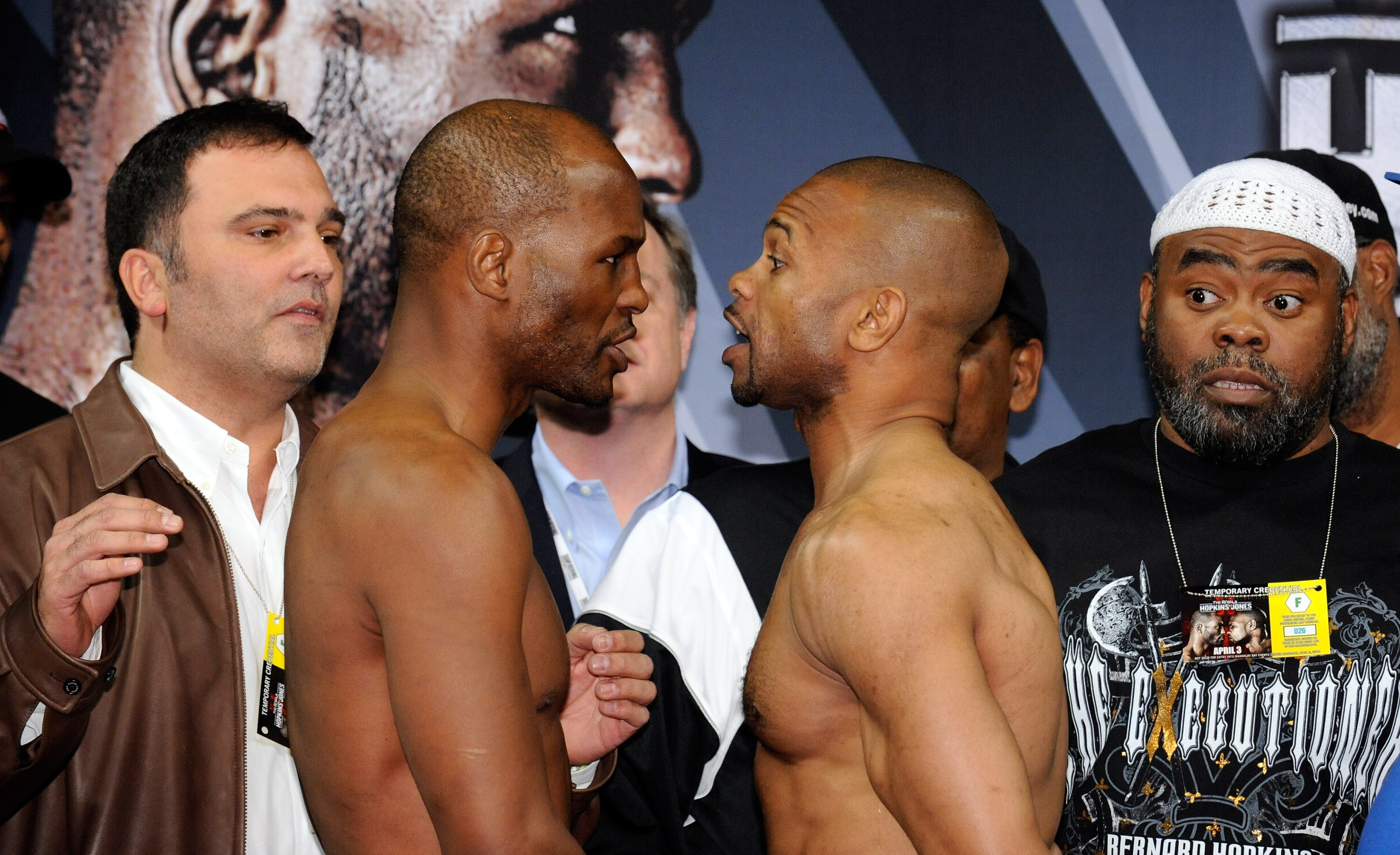 LAS VEGAS - APRIL 02:  Boxers Bernard Hopkins (2nd L) and Roy Jones Jr. face off during the official weigh-in for their bout at the Mandalay Bay Events Center as Golden Boy Promotions CEO Richard Schaefer (L) and Hopkins' trainer Nazim Richardson (R) look