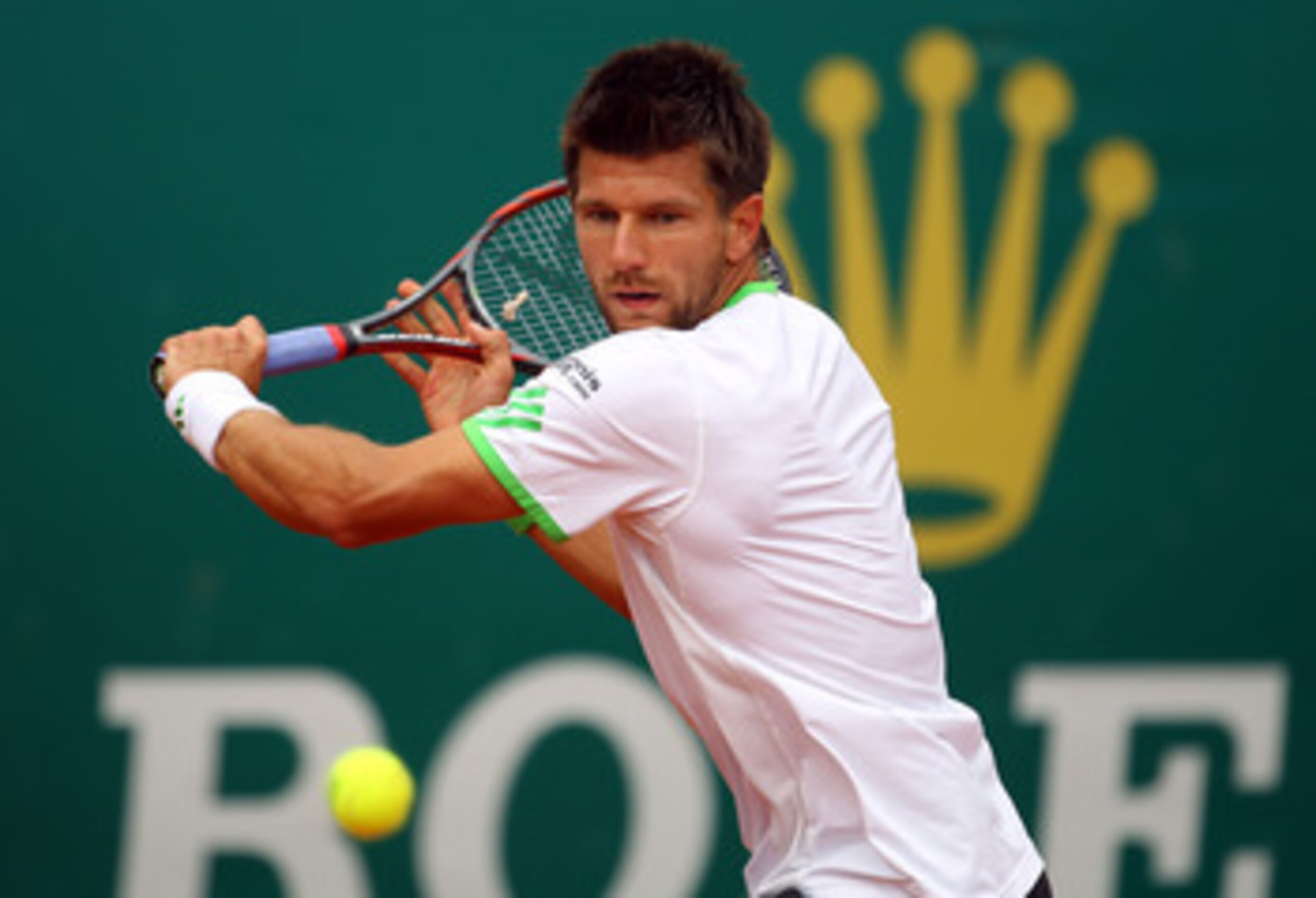 MONACO - APRIL 15:   Jurgen Melzer of Austria plays a backhand in his match against Roger Federer of Switzerland during Day Six of the ATP Masters Series Tennis at the Monte Carlo Country Club on April 15, 2011 in Monte Carlo, Monaco.  (Photo by Julian Fi