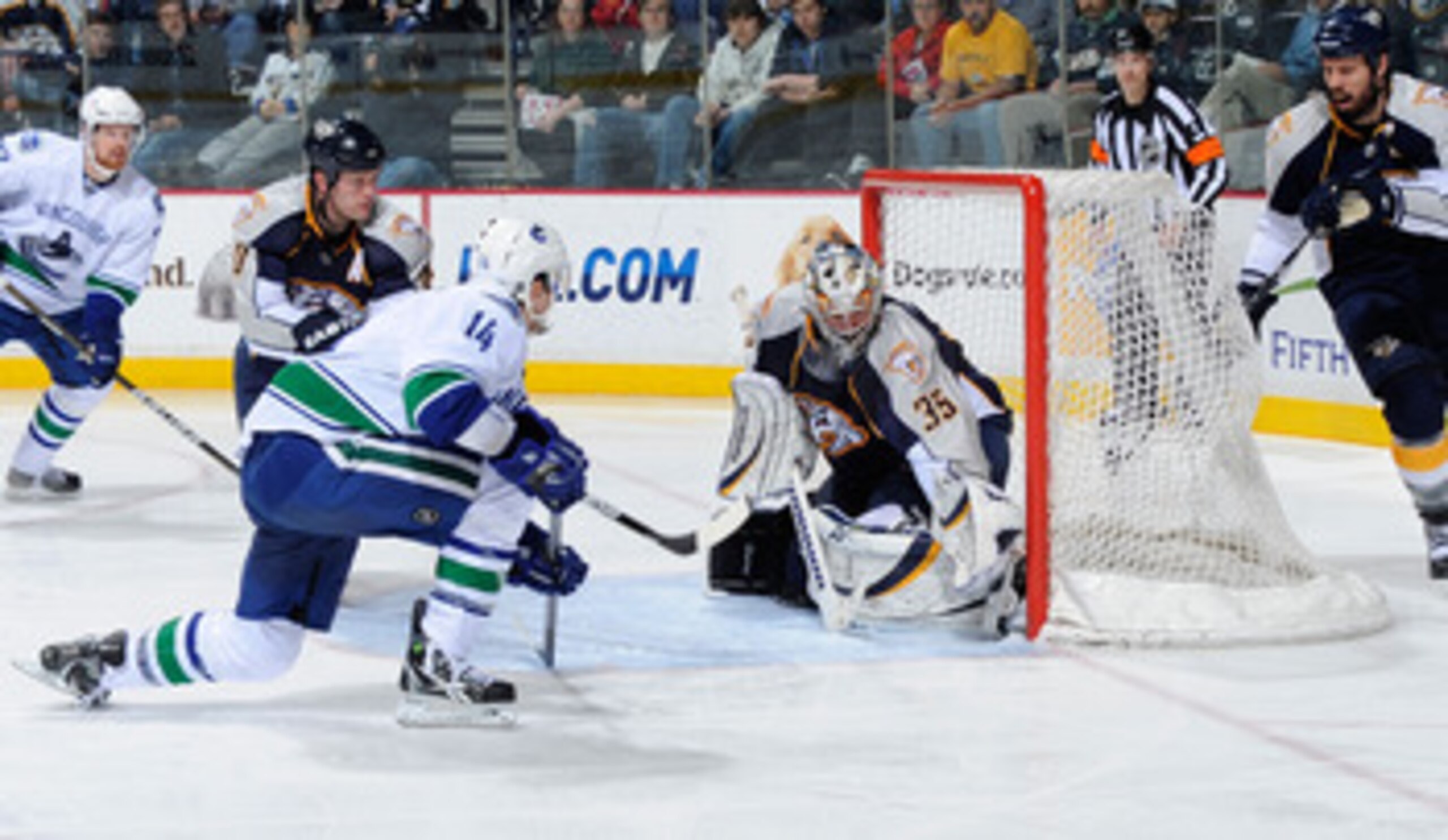NASHVILLE, TN - MARCH 29:  Alexandre Burrows #14 of the Vancouver Canucks scores a goal on Pekka Rinne #35 of the Nashville Predators on March 29, 2011 at the Bridgestone Arena in Nashville, Tennessee.  (Photo by Frederick Breedon/Getty Images)