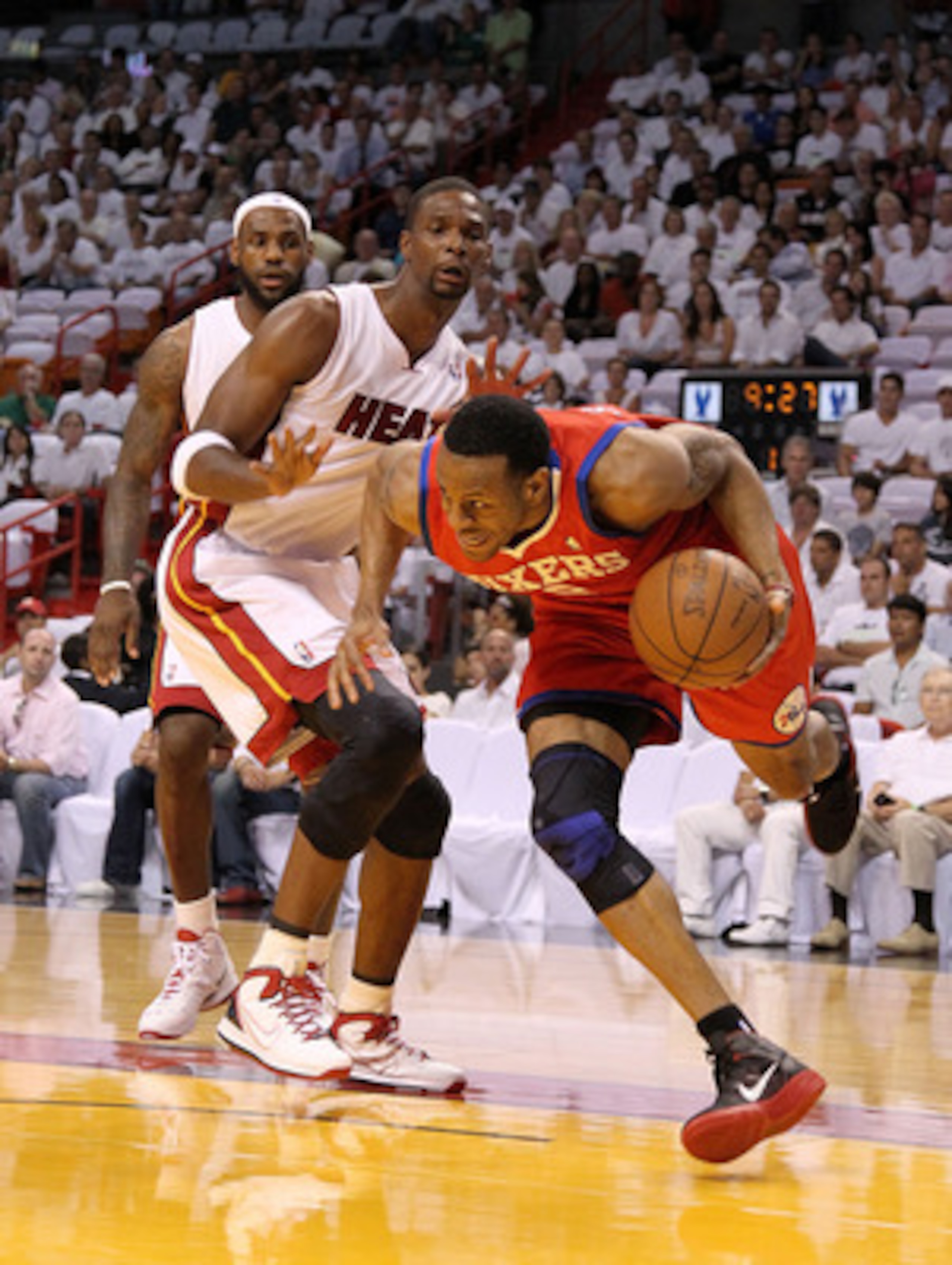 MIAMI, FL - APRIL 27:  Andre Iguodala #9 of the Philadelphia 76ers drives to the rim past LeBron James #6 and Chris Bosh #1 of the Miami Heat during game five of the Eastern Conference Quarterfinals in the 2011 NBA Playoffs at American Airlines Arena on A
