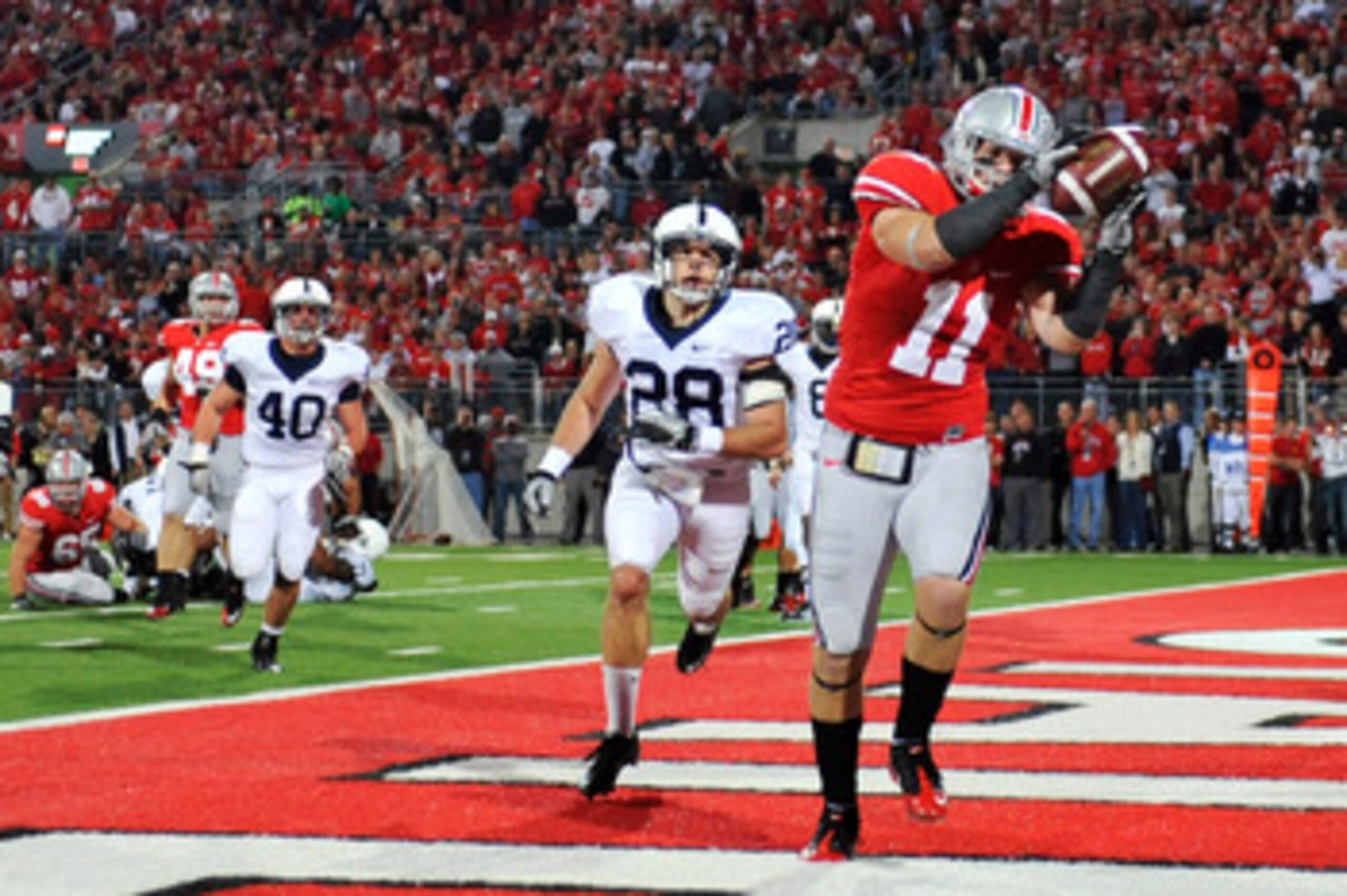 COLUMBUS, OH - NOVEMBER 13:  Jake Stoneburner #11 of the Ohio State Buckeyes makes a three yard touchdown reception in front of Drew Astorino #28 of the Penn State Nittany Lions at Ohio Stadium on November 13, 2010 in Columbus, Ohio. Ohio State defeated P
