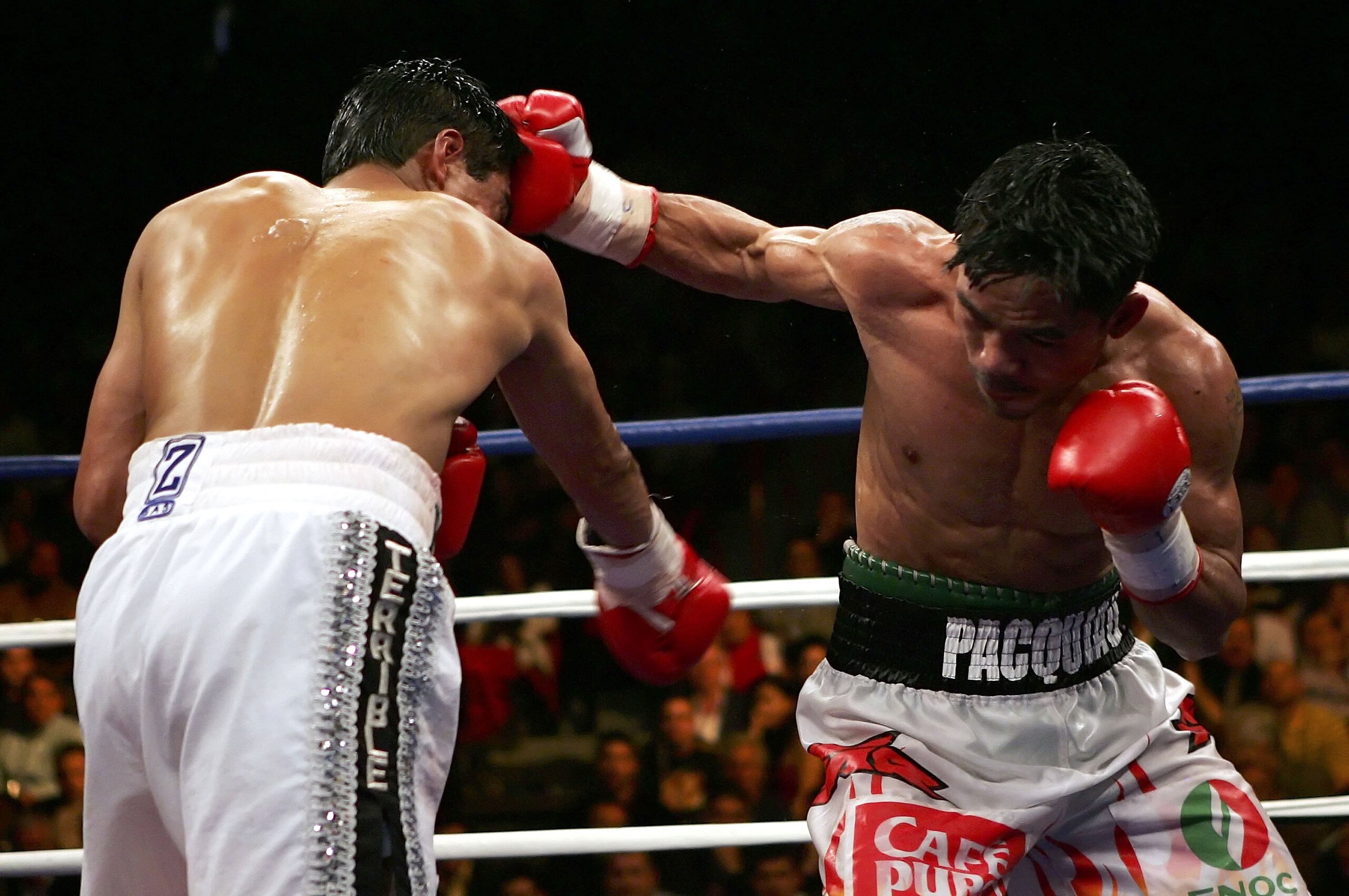 LAS VEGAS - JANUARY 21:  (R-L) Manny Pacquiao of the Phillippines lands a right on Erik Morales of Mexico during their Super Featherweight Championship fight at Thomas & Mack Arena on January 21, 2006 in Las Vegas, Nevada. Pacquiao defeated Morales by a 1