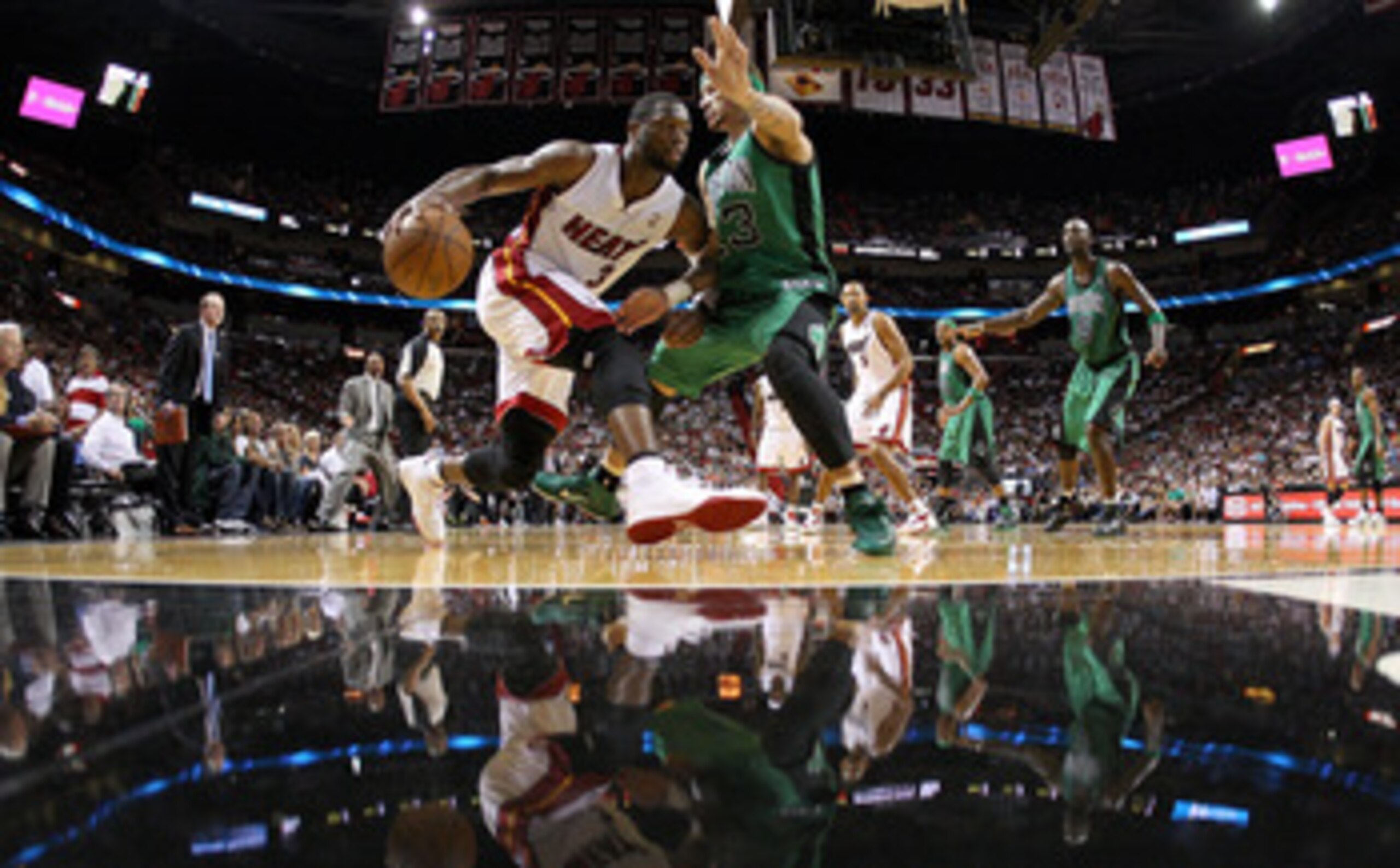 MIAMI, FL - APRIL 10:  Dwyane Wade #3 of the Miami Heat drives on Delonte West #13 of the Boston Celtics during a game  at American Airlines Arena on April 10, 2011 in Miami, Florida. NOTE TO USER: User expressly acknowledges and agrees that, by downloadi
