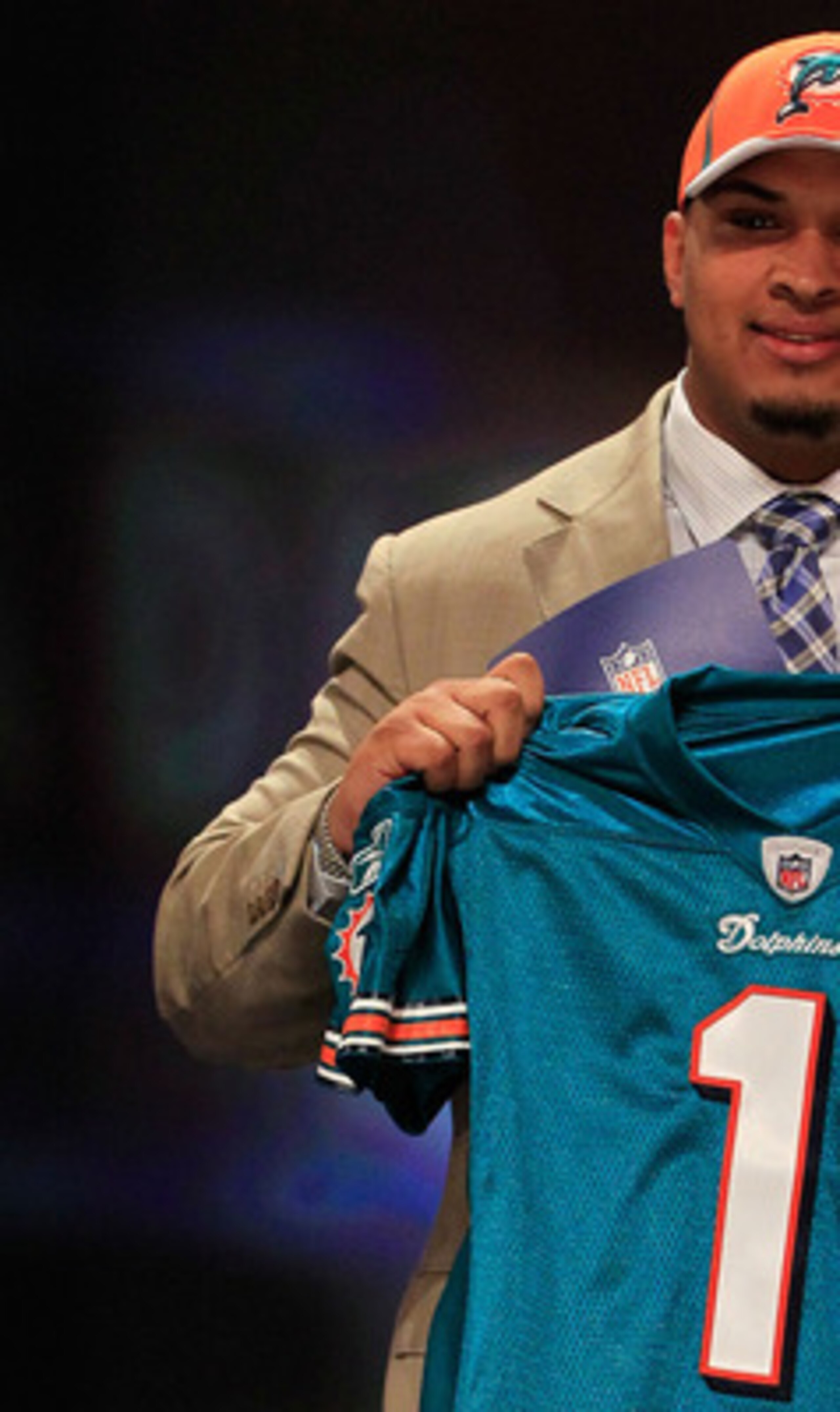 NEW YORK, NY - APRIL 28: Mike Pouncey, #15 overall pick by the Miami Dolphins, holds up a jersey on stage during the 2011 NFL Draft at Radio City Music Hall on April 28, 2011 in New York City. (Photo by Chris Trotman/Getty Images) NEW YORK, NY - APRIL 28: Mike Pouncey, #15 overall pick by the Miami Dolphins, holds up a jersey on stage during the 2011 NFL Draft at Radio City Music Hall on April 28, 2011 in New York City. (Photo by Chris Trotman/Getty Images)