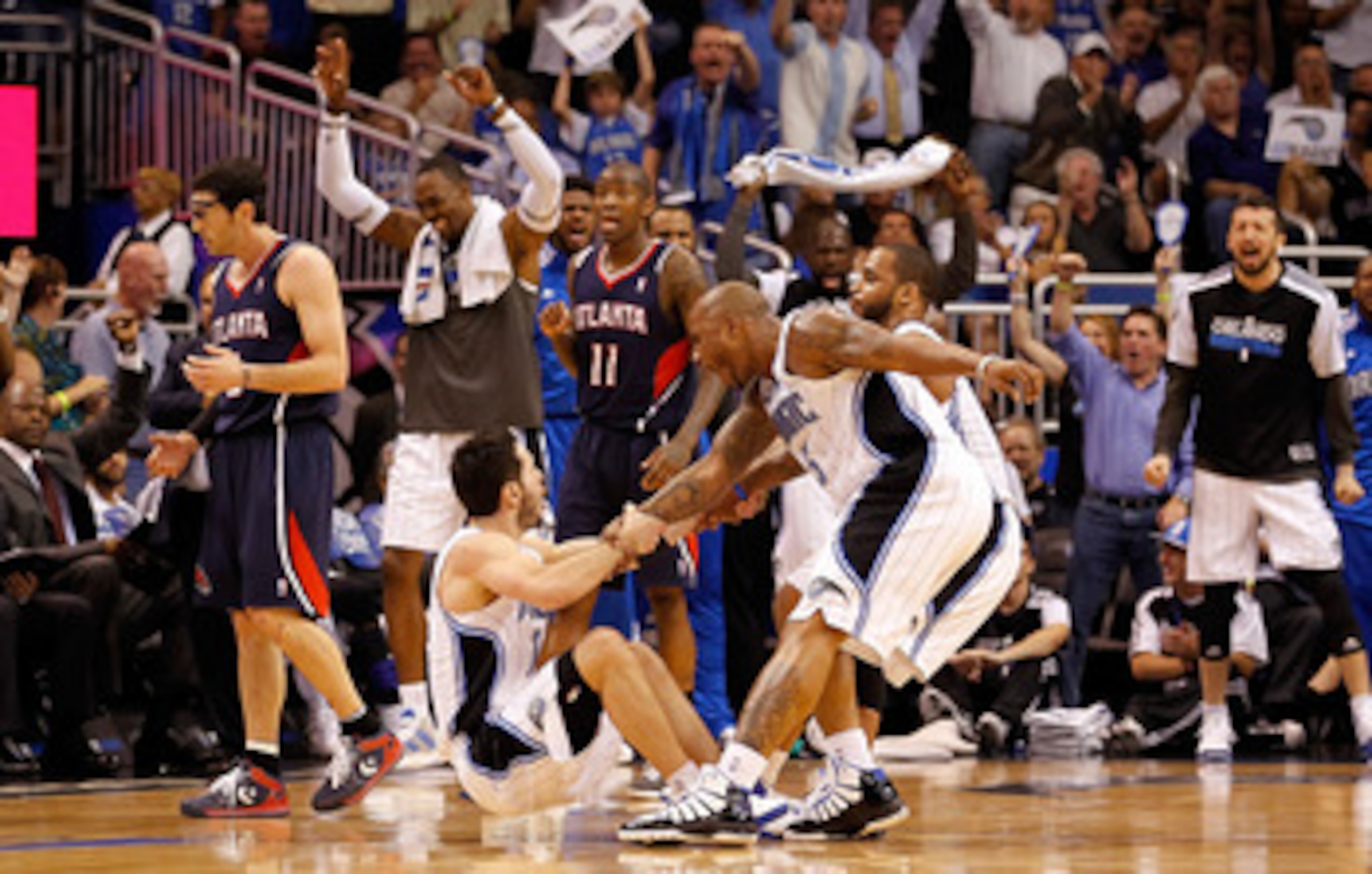 ORLANDO, FL - APRIL 26:  J.J. Redick #7 of the Orlando Magic is fouled by Kirk Hinrich #6 of the Atlanta Hawks on a three point shot during Game Five of the Eastern Conference Quarterfinals of the 2011 NBA Playoffs on April 26, 2011 at the Amway Arena in 