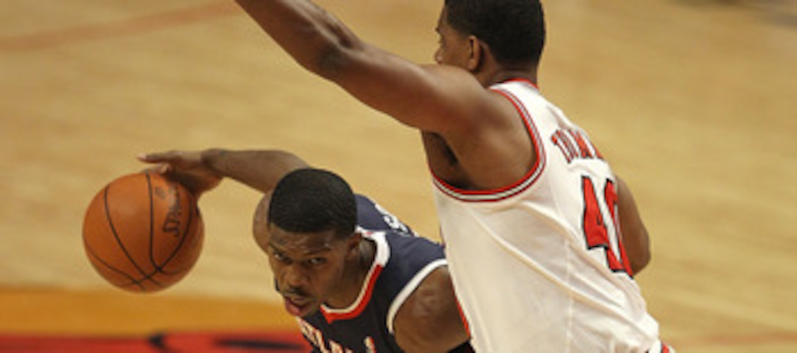 CHICAGO, IL - MARCH 11: Joe Johnson #2 of the Atlanta Hawks moves against Kurt Thomas #40 of the Chicago Bulls at the United Center on March 11, 2011 in Chicago, Illinois. NOTE TO USER: User expressly acknowledges and agrees that, by downloading and/or us