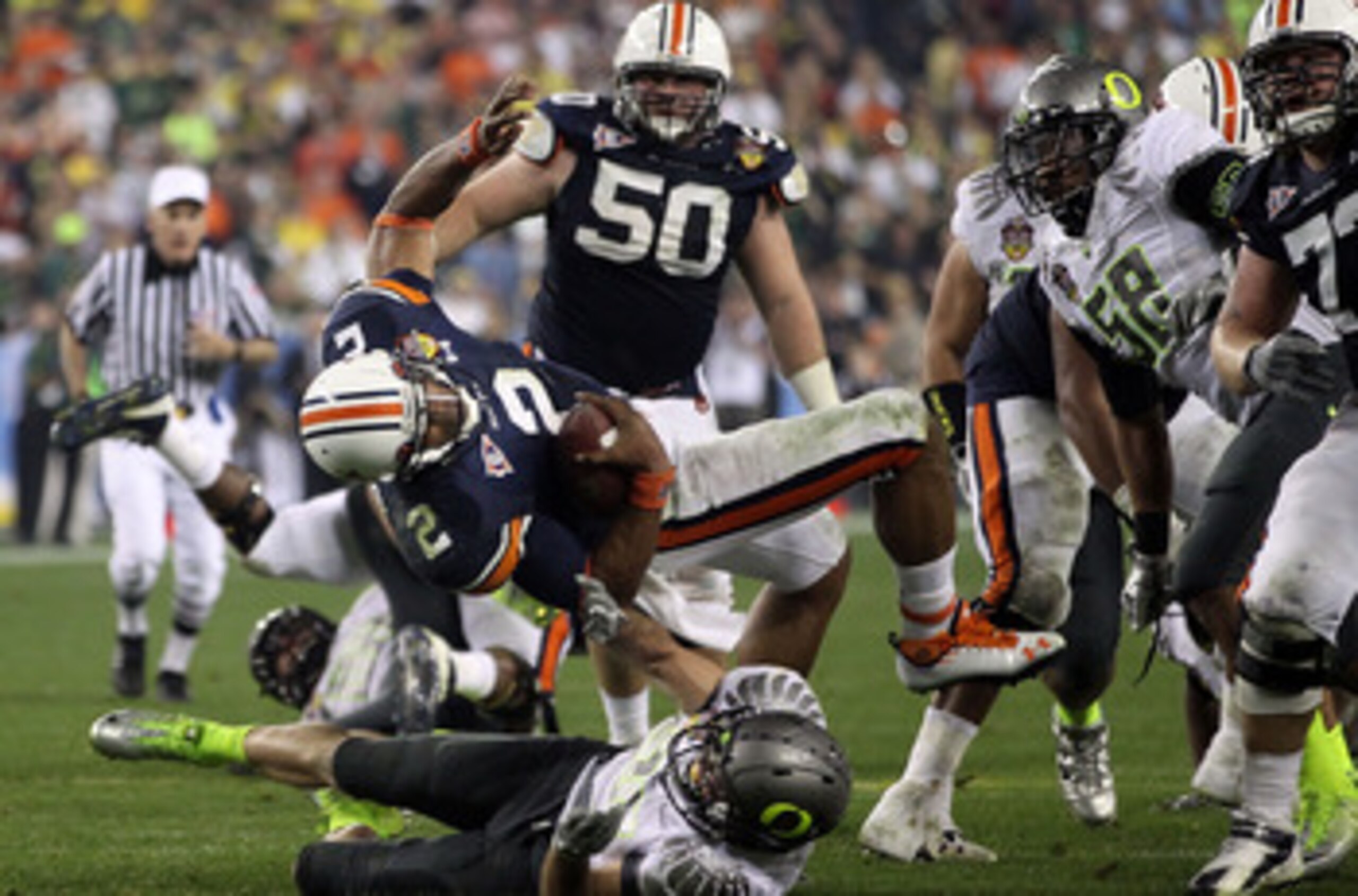 GLENDALE, AZ - JANUARY 10:  Cameron Newton #2 of the Auburn Tigers is brought down by John Boyett #20 of the Oregon Ducks during the Tostitos BCS National Championship Game at University of Phoenix Stadium on January 10, 2011 in Glendale, Arizona.  (Photo