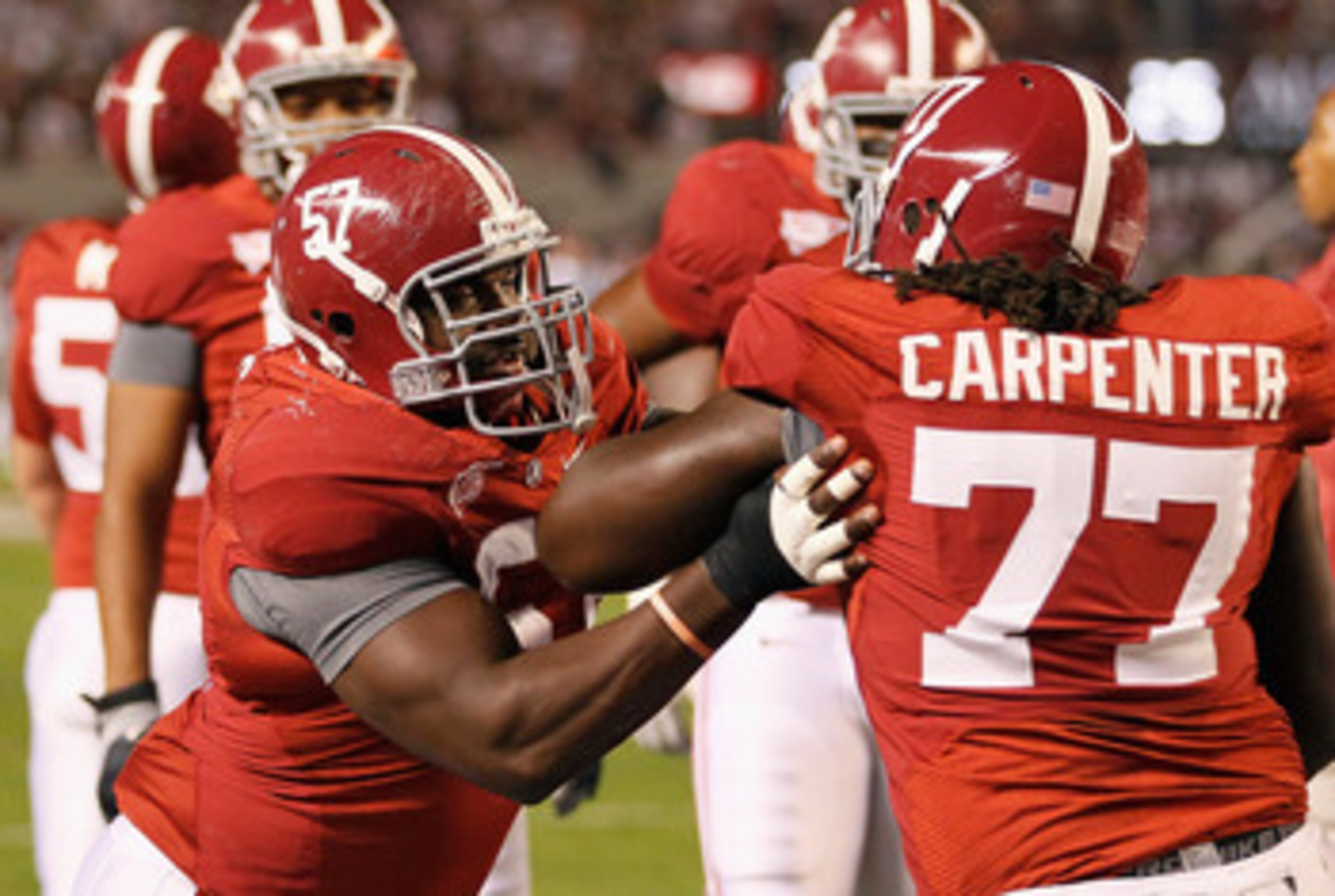 TUSCALOOSA, AL - OCTOBER 16: Marcell Dareus #57 and James Carpenter #77 of the Alabama Crimson Tide against the Ole Miss Rebels at Bryant-Denny Stadium on October 16, 2010 in Tuscaloosa, Alabama. (Photo by Kevin C. Cox/Getty Images) TUSCALOOSA, AL - OCTOBER 16: Marcell Dareus #57 and James Carpenter #77 of the Alabama Crimson Tide against the Ole Miss Rebels at Bryant-Denny Stadium on October 16, 2010 in Tuscaloosa, Alabama. (Photo by Kevin C. Cox/Getty Images)