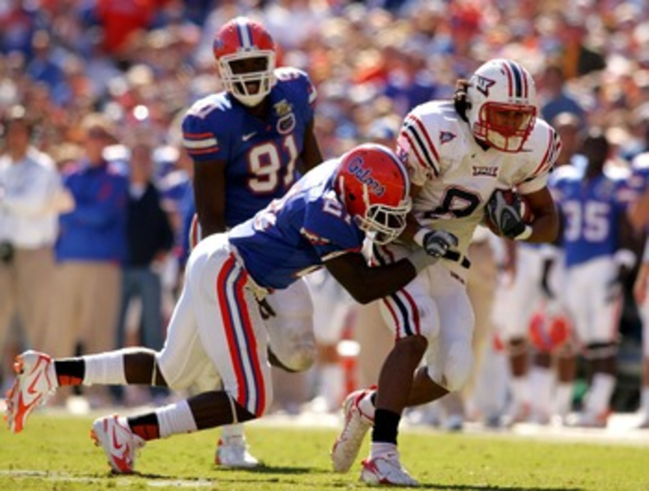 GAINESVILLE, FL - NOVEMBER 17:  Rob Housler #81 of the FAU Owls is tackled by Major Wright #21 of the Florida Gators during a game at Ben Hill Griffin Stadium on November 17, 2007 in Gainesville, Florida.  The Gators won the game 59-20.  (Photo by Sam Gre