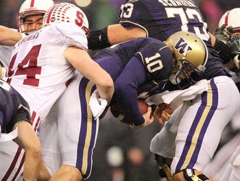 SEATTLE - OCTOBER 30:  Quarterback Jake Locker #10 of the Washington Huskies is tackled by Chase Thomas #44 of the Stanford Cardinal on October 30, 2010 at Husky Stadium in Seattle, Washington. (Photo by Otto Greule Jr/Getty Images)