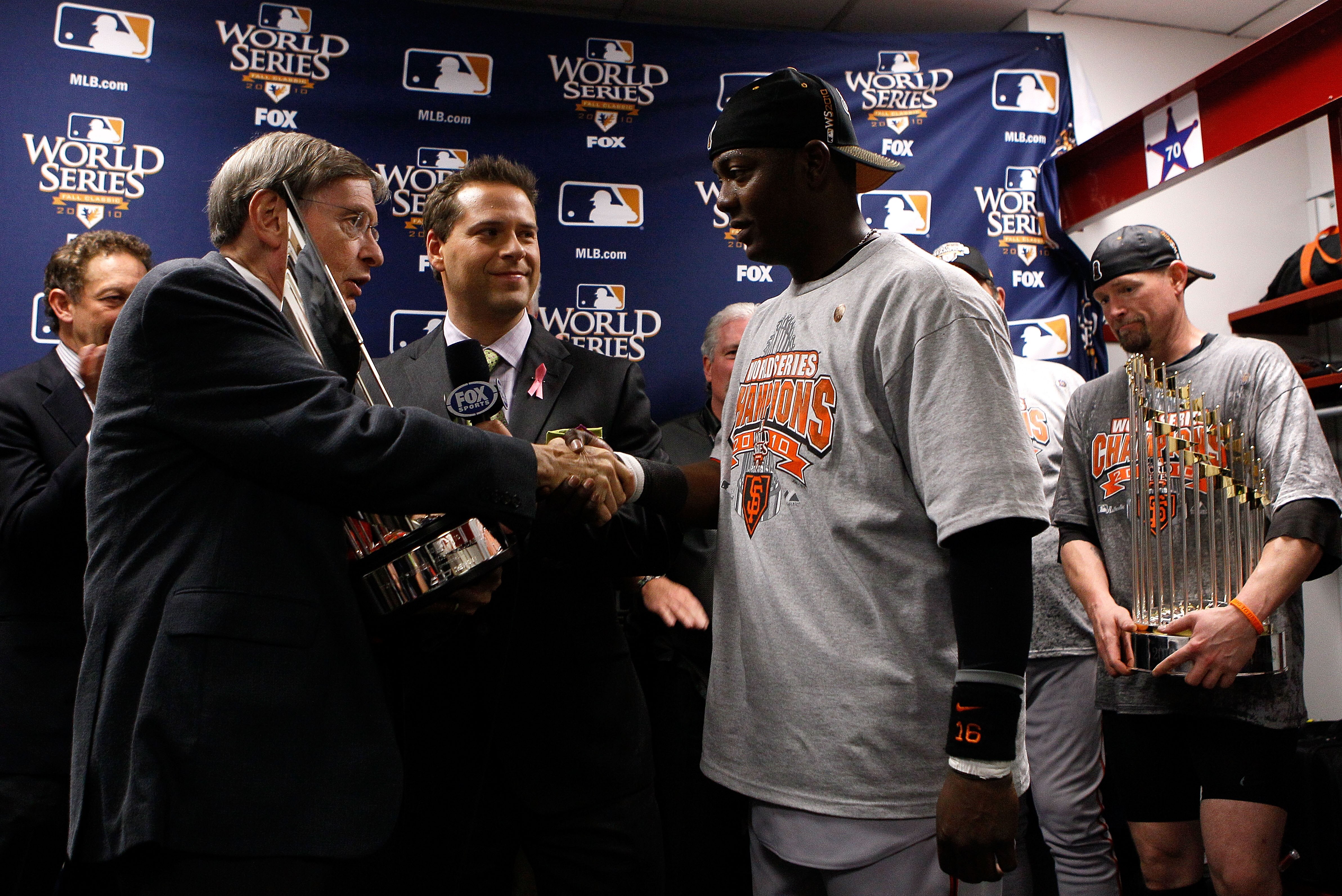 ARILINGTON, TX - NOVEMBER 1:  World Series MVP Edgar Renteria of the San Francisco Giants receives his MVP trophy from Major League Baseball Commissioner Bud Selig in the locker room after the Giants won 3-1 against the Texas Rangers in Game Five of the 2